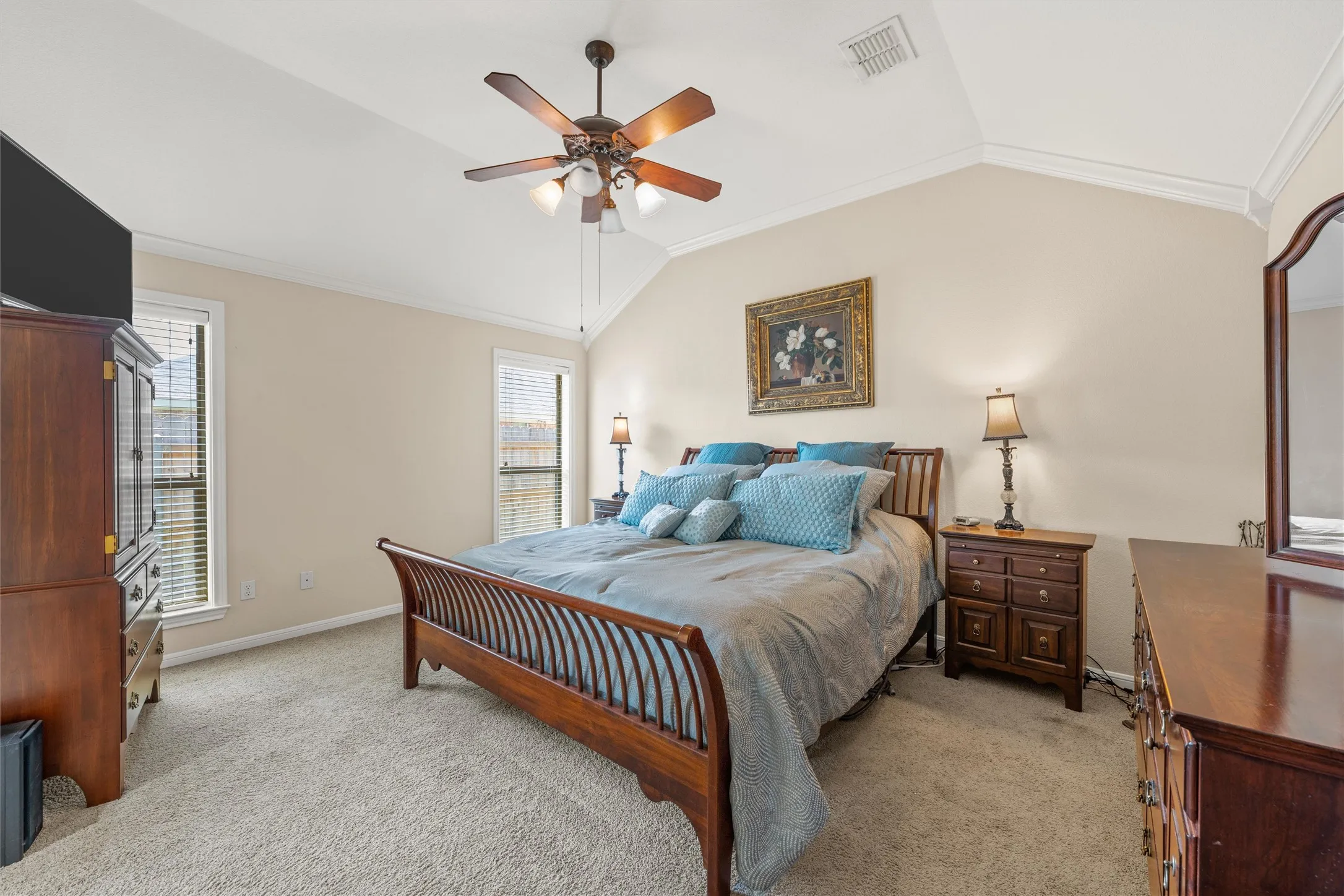 Bedroom featuring a vaulted ceiling and a ceiling fan with integrated lighting