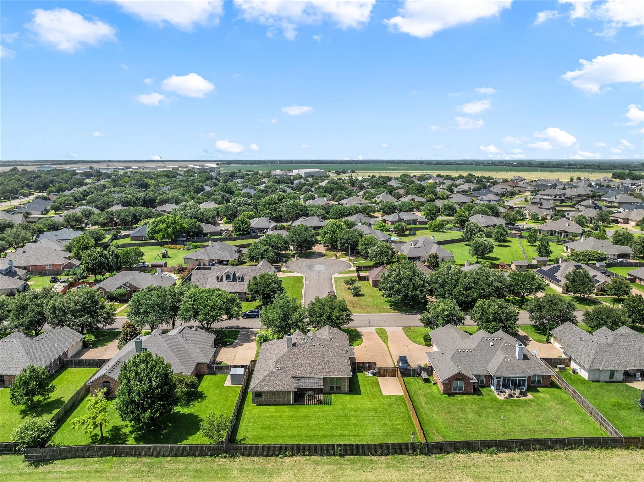 Expansive residential community featuring a variety of single-story homes with mature trees and manicured lawns