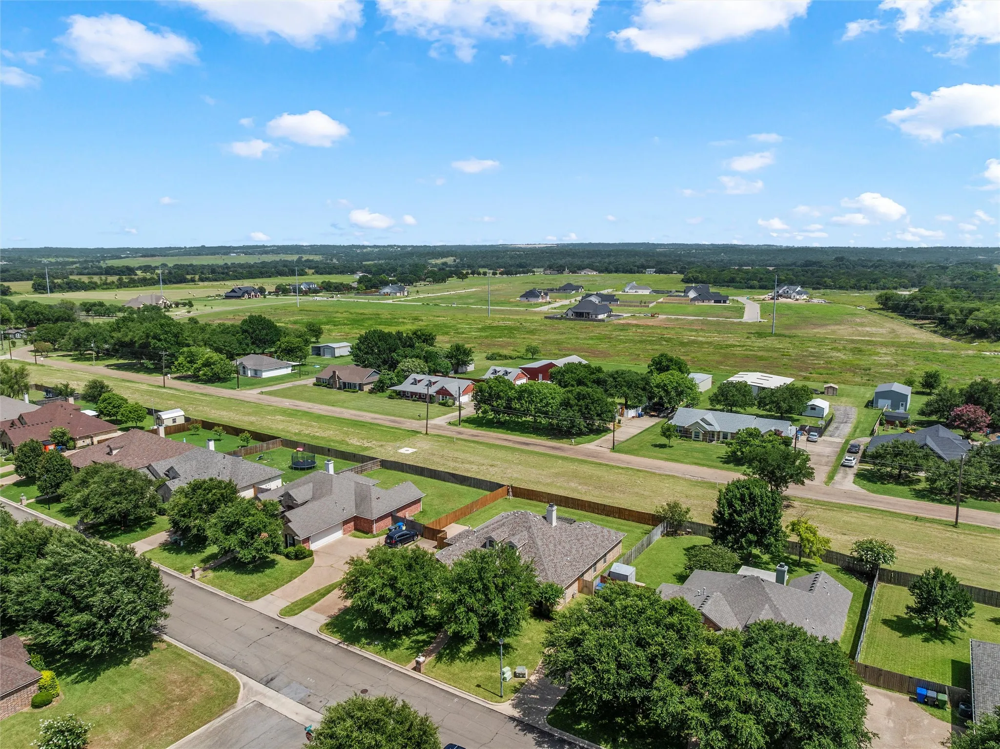 Aerial perspective showcasing residential properties amidst expansive green spaces