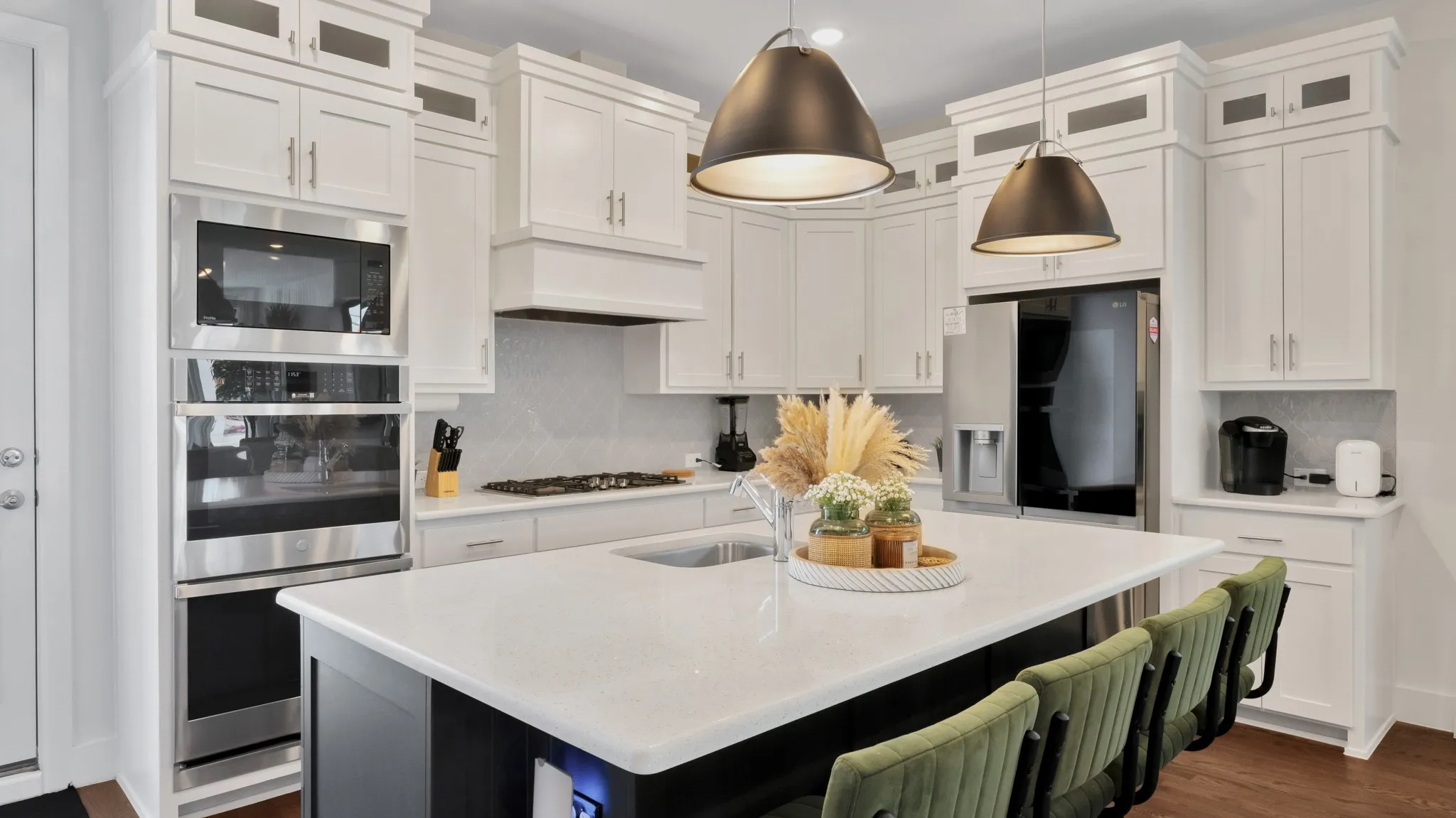 Contemporary kitchen island with a white solid surface countertop