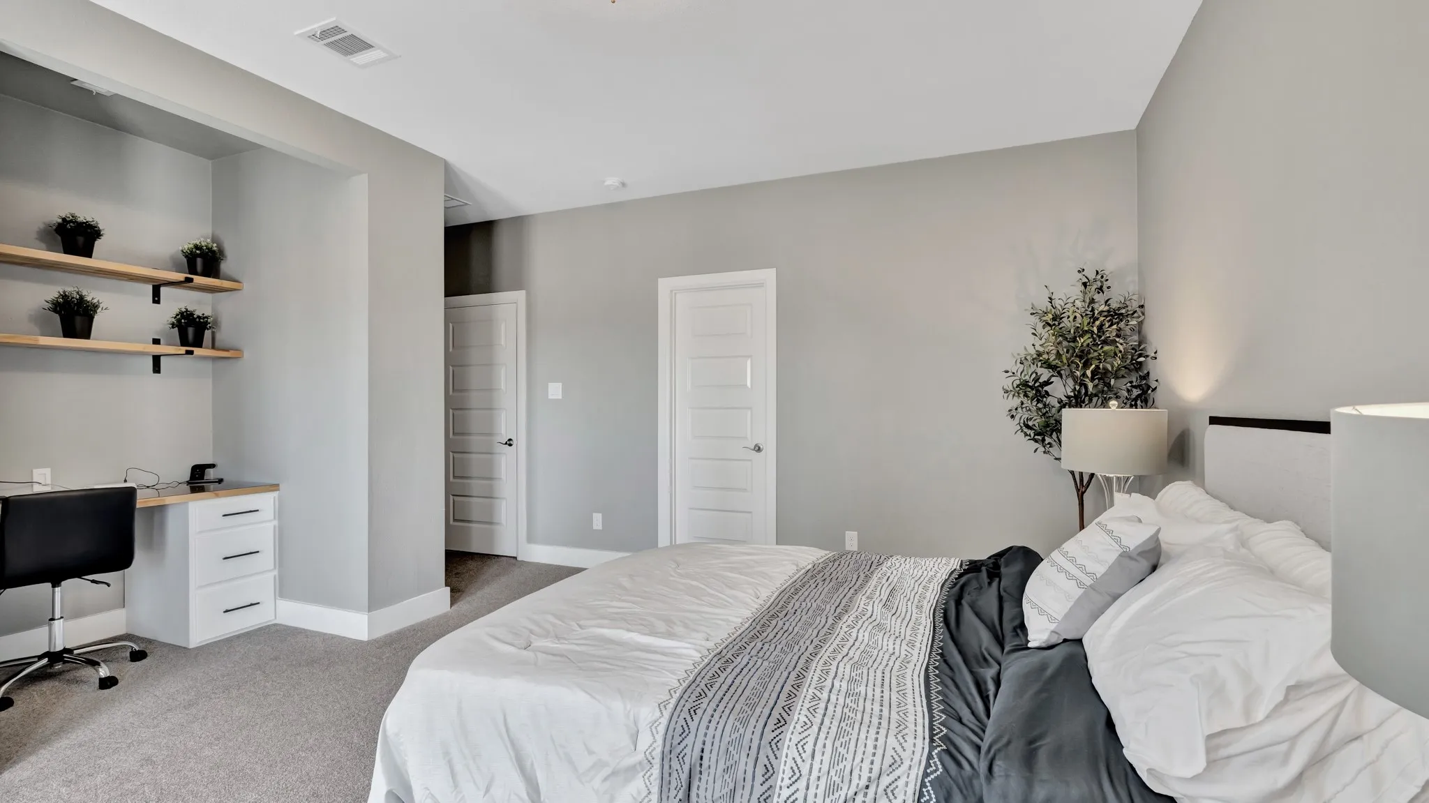 Third level, secondary bedroom, with a dedicated desk area with built-in cabinetry and floating wood shelves