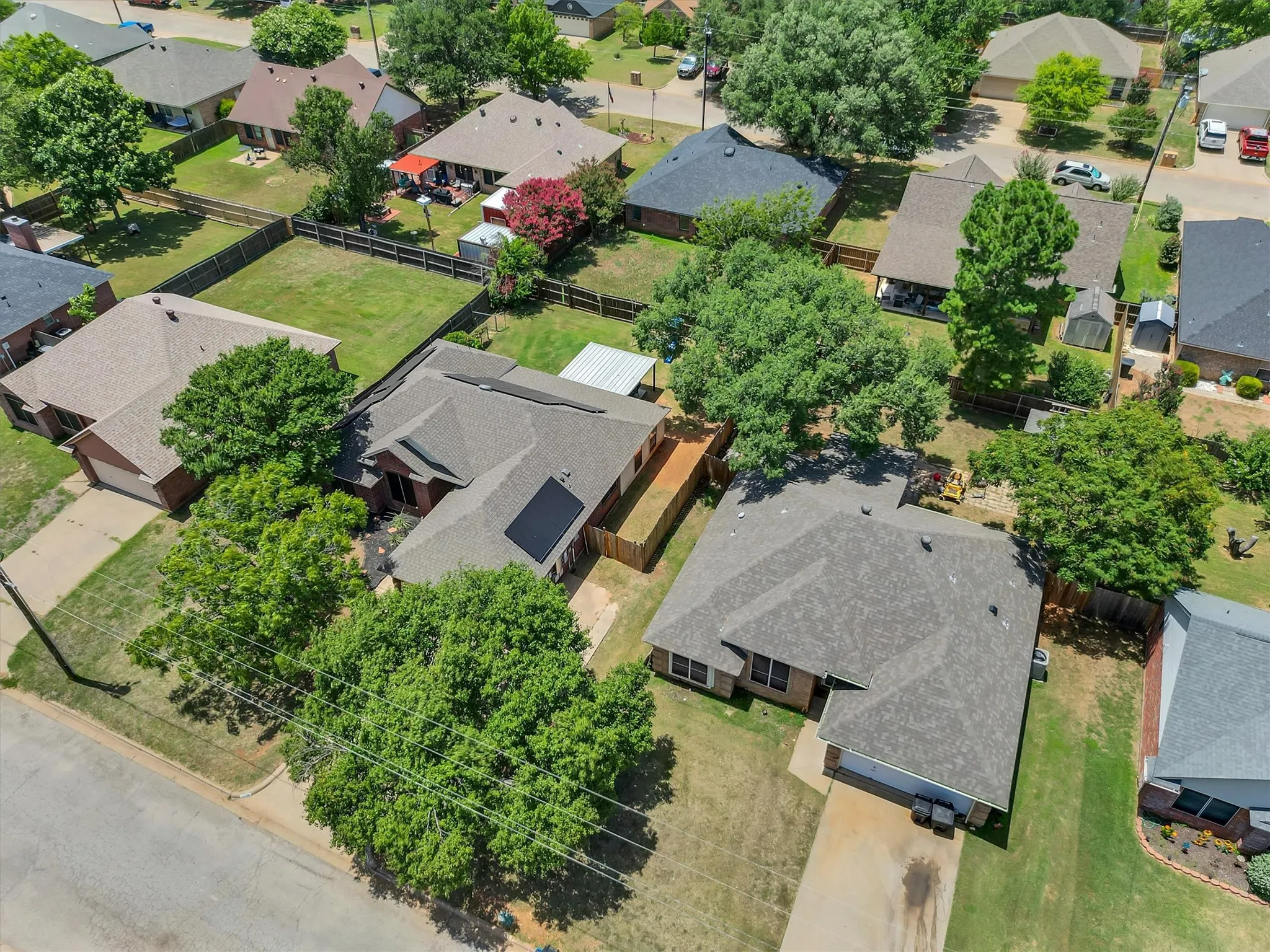 Overhead view showcasing a residential property with a shingle roof