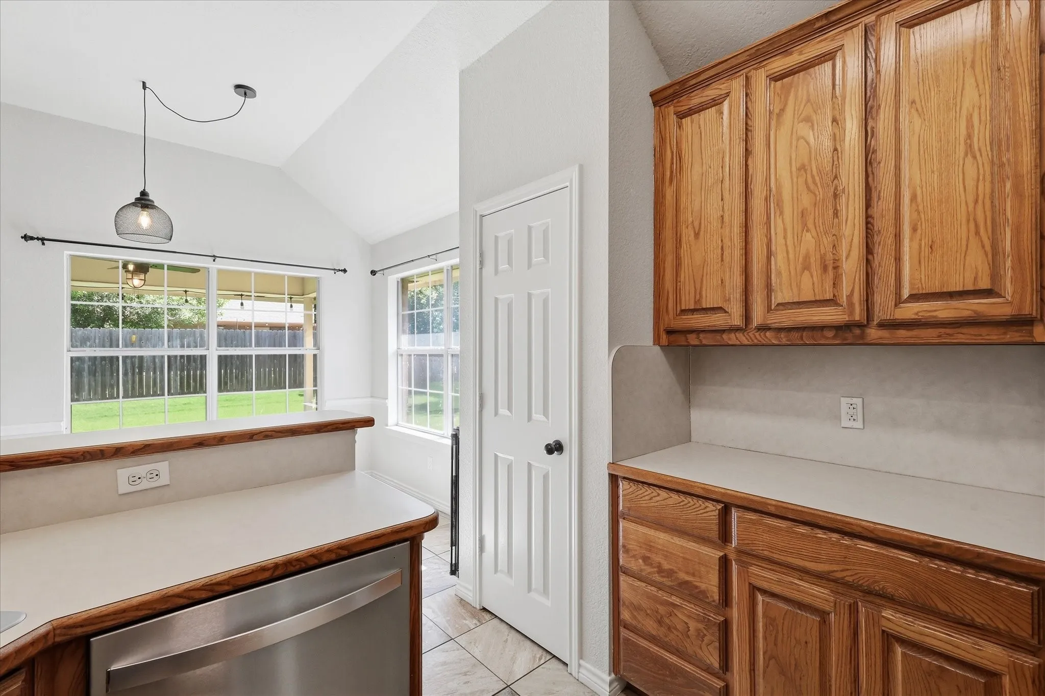 Kitchen area featuring light wood cabinetry and light countertops
