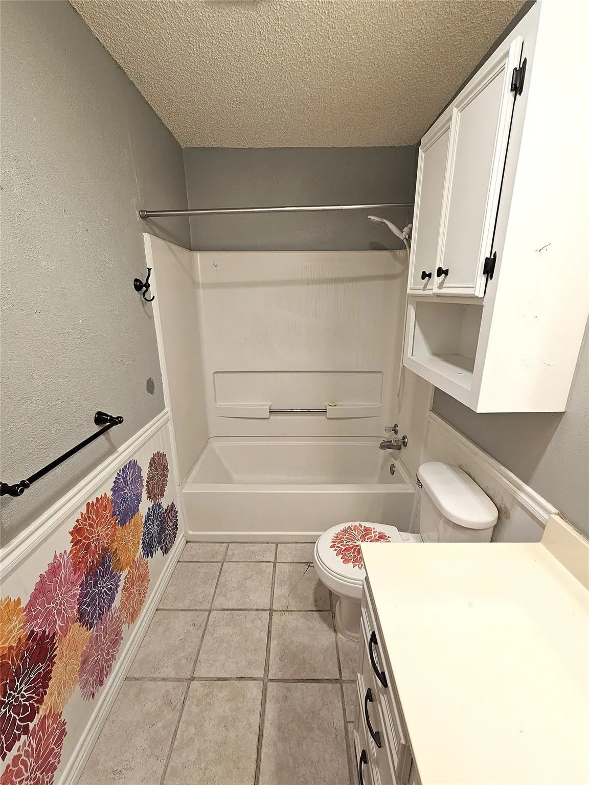 Full bathtub with an integrated shower, complemented by a built-in vanity with a countertop