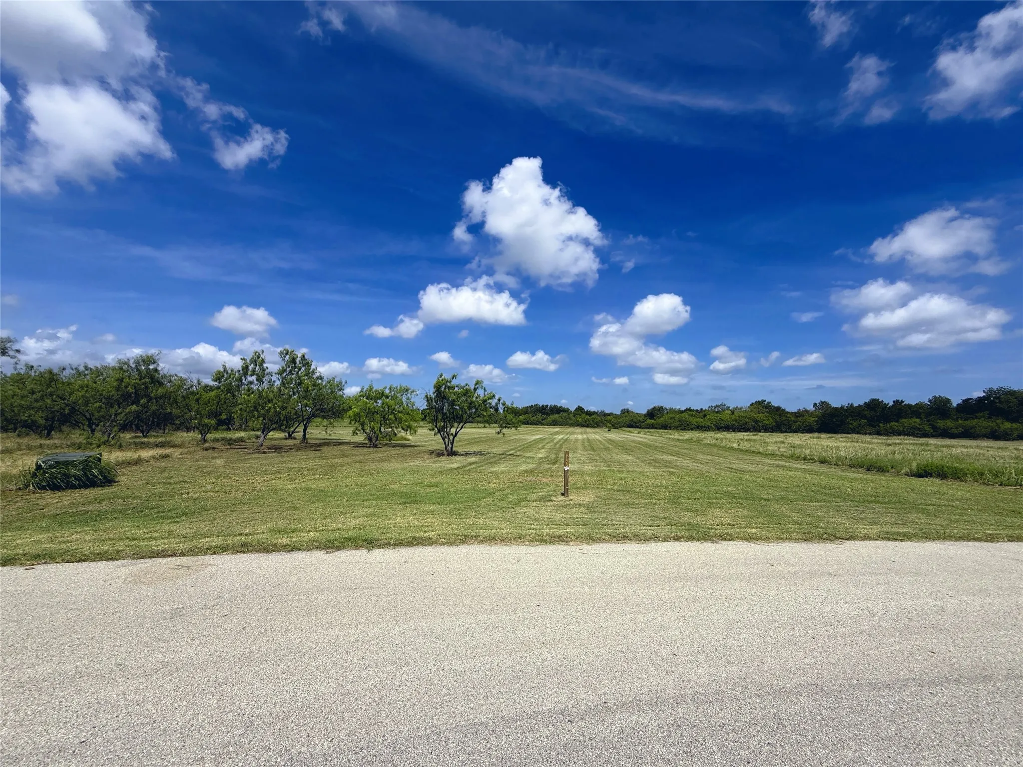 Wide road frontage welcomes you to this spacious homesite with room to create your ideal custom retreat.