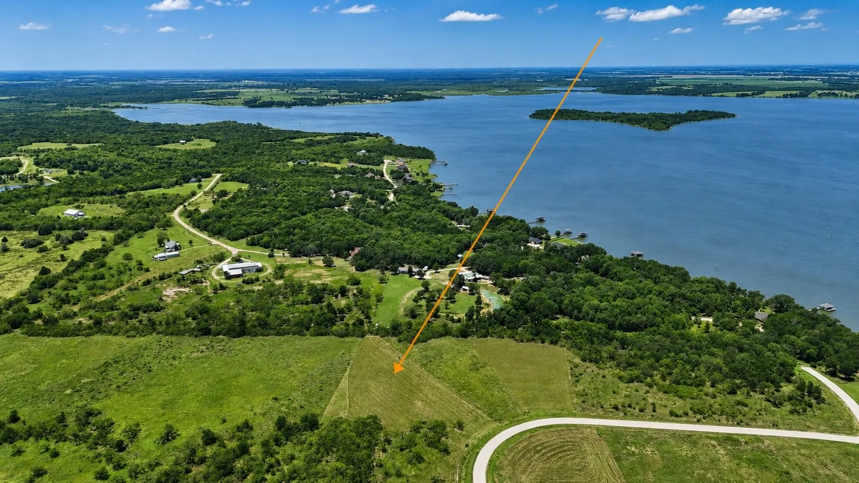 Enjoy a scenic perspective of the property with beautiful lake views in the distance.