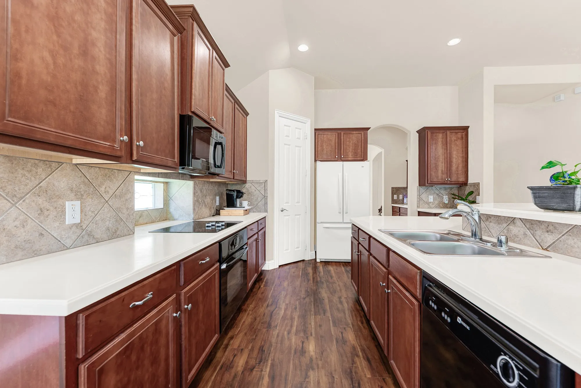 The oversized island anchors the kitchen, while the desirable corner walk-in pantry provides exceptional storage. A gas stub is already in place, making it easy to convert the electric cooktop to gas if desired.