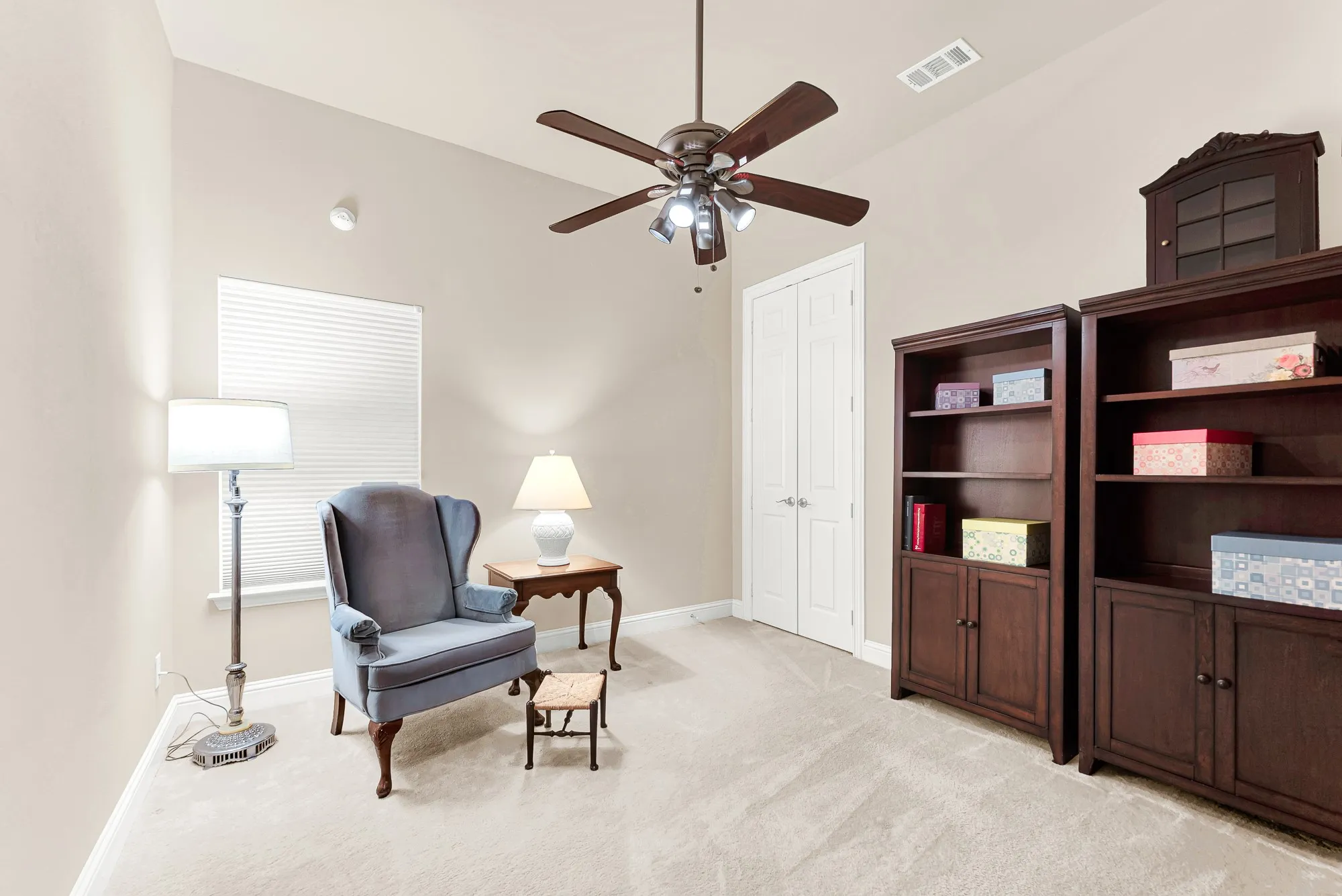 Comfortable secondary bedroom with vaulted ceilings, ceiling fan, plush carpet, and generous wall space for flexible furniture placement.