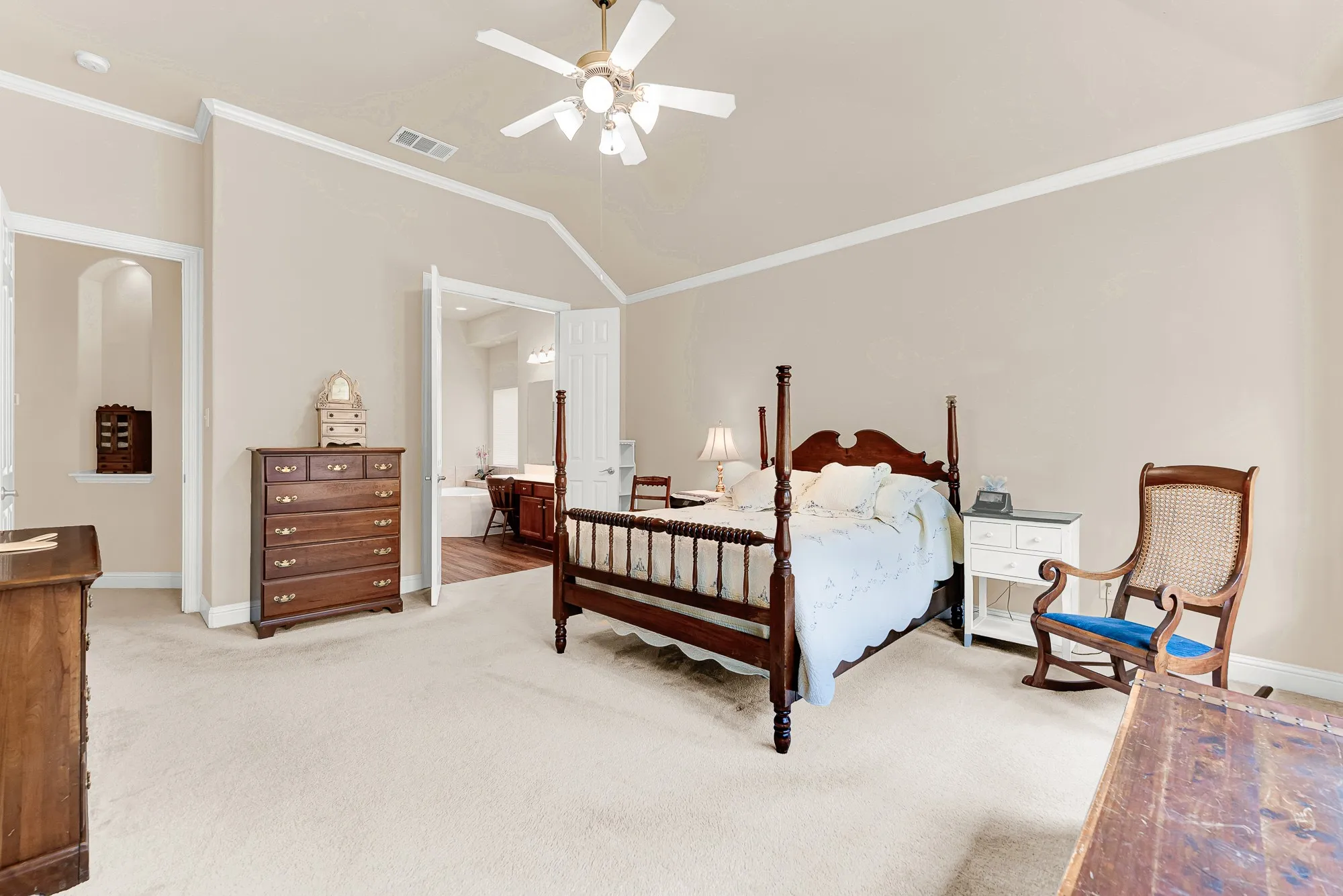 The oversized primary bedroom easily accommodates large furnishings while offering direct access to the luxurious ensuite bath. High ceilings and neutral finishes create an inviting retreat.