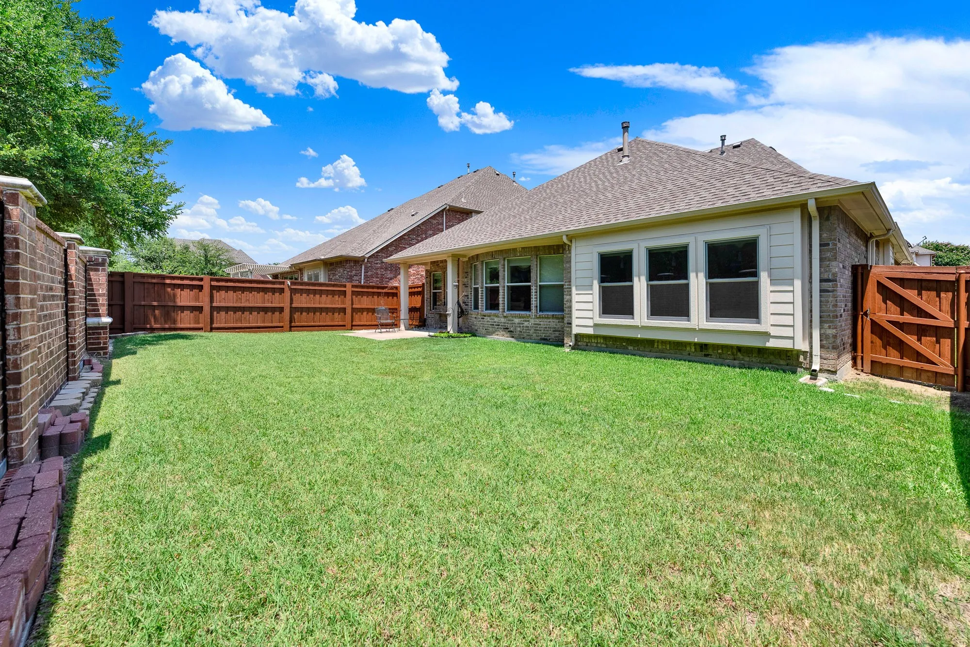 A spacious backyard offers endless possibilities for recreation, gardening, or adding future outdoor amenities. The privacy fence creates a secure setting for pets and play.