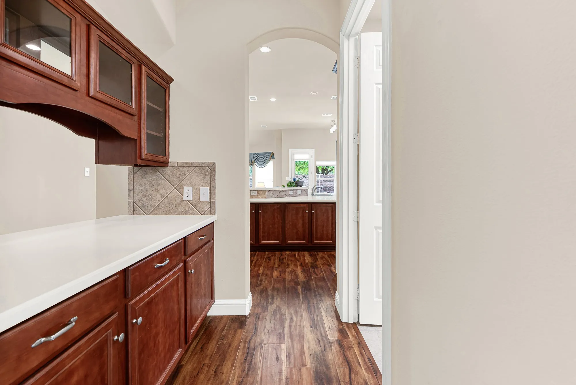A dedicated butler's pantry provides exceptional storage and prep space, featuring abundant cabinetry, generous countertops, and an ideal setup for serving, entertaining, or creating a convenient coffee or beverage station.