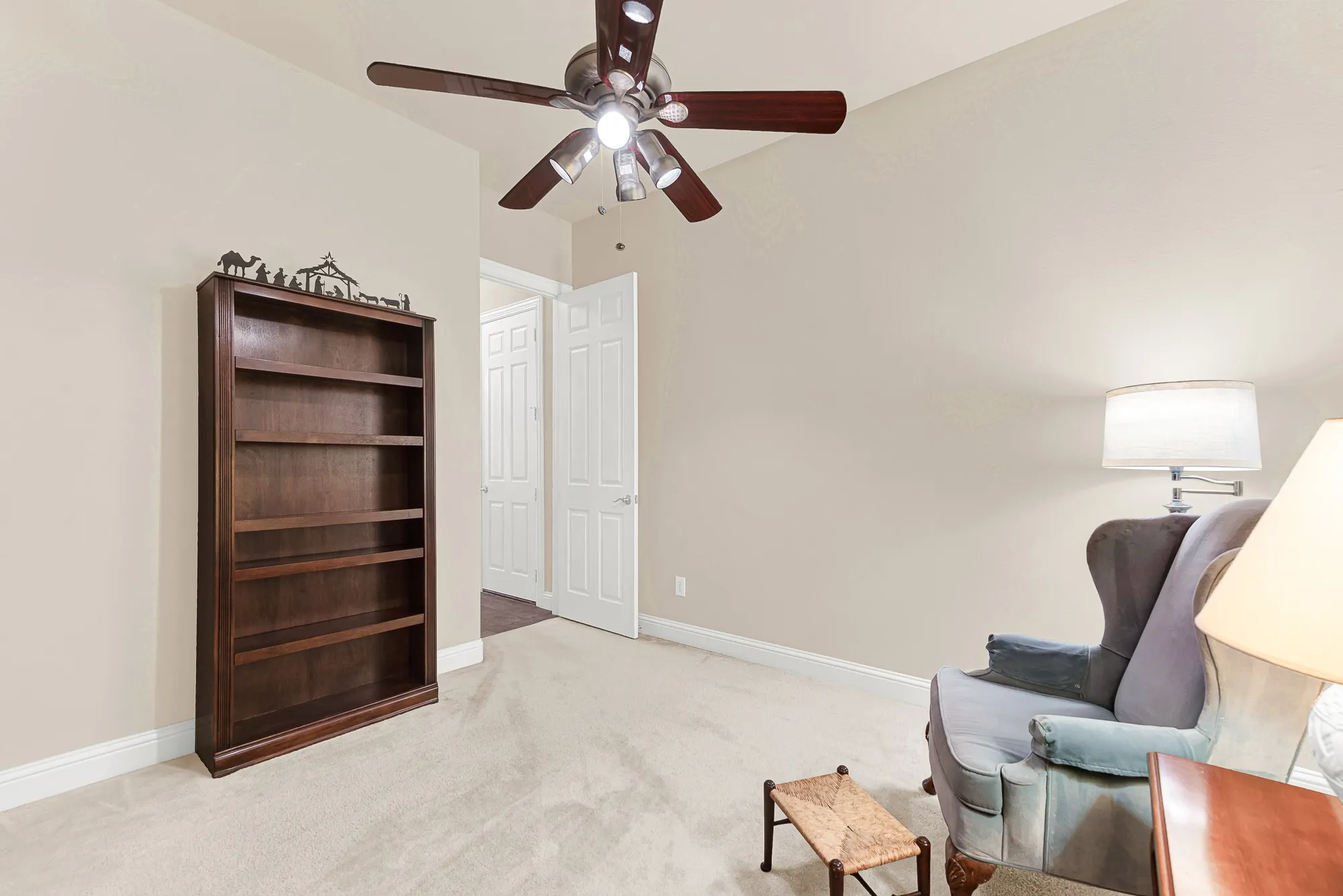 This bright secondary bedroom offers a spacious layout, vaulted ceiling, ceiling fan, and ample closet space, making it ideal for guests, family, or a dedicated home office.