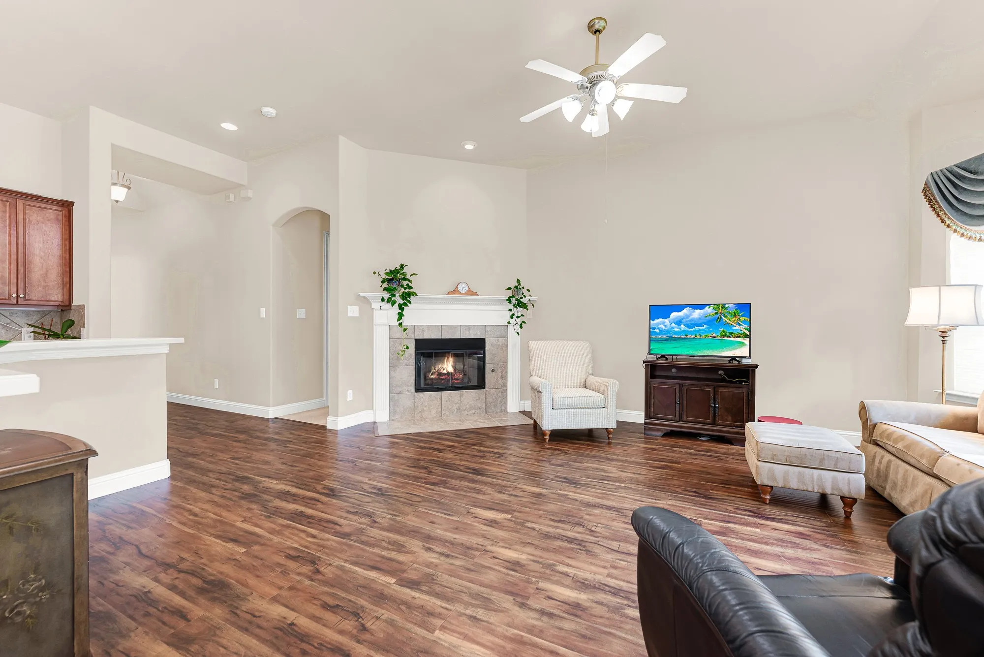 A beautiful gas fireplace serves as the focal point of the living room, adding warmth and character to this inviting space with generous proportions and an airy, open feel.