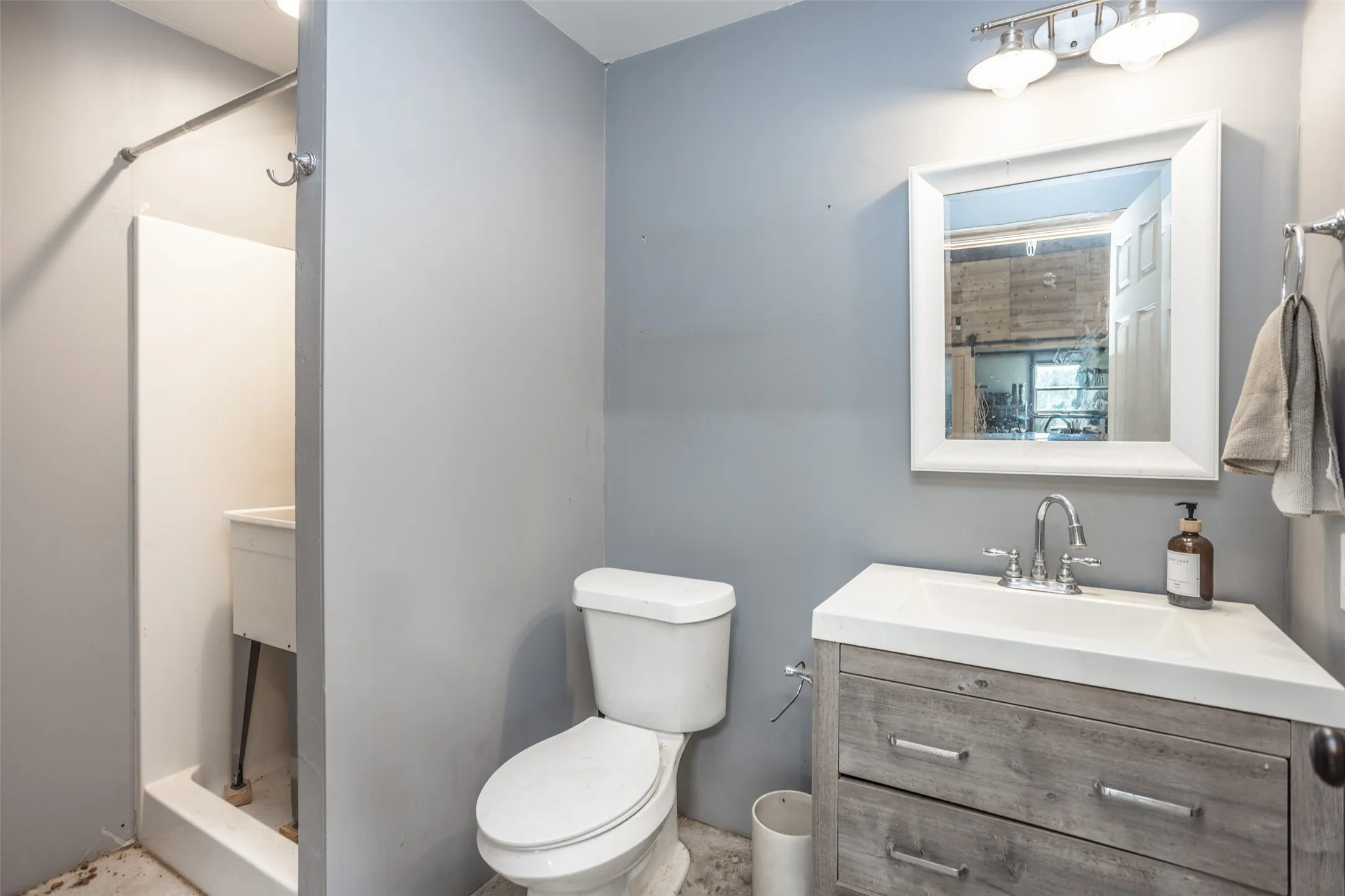 Shop Bath features toilet, sink, shower and tankless electric hot water heater