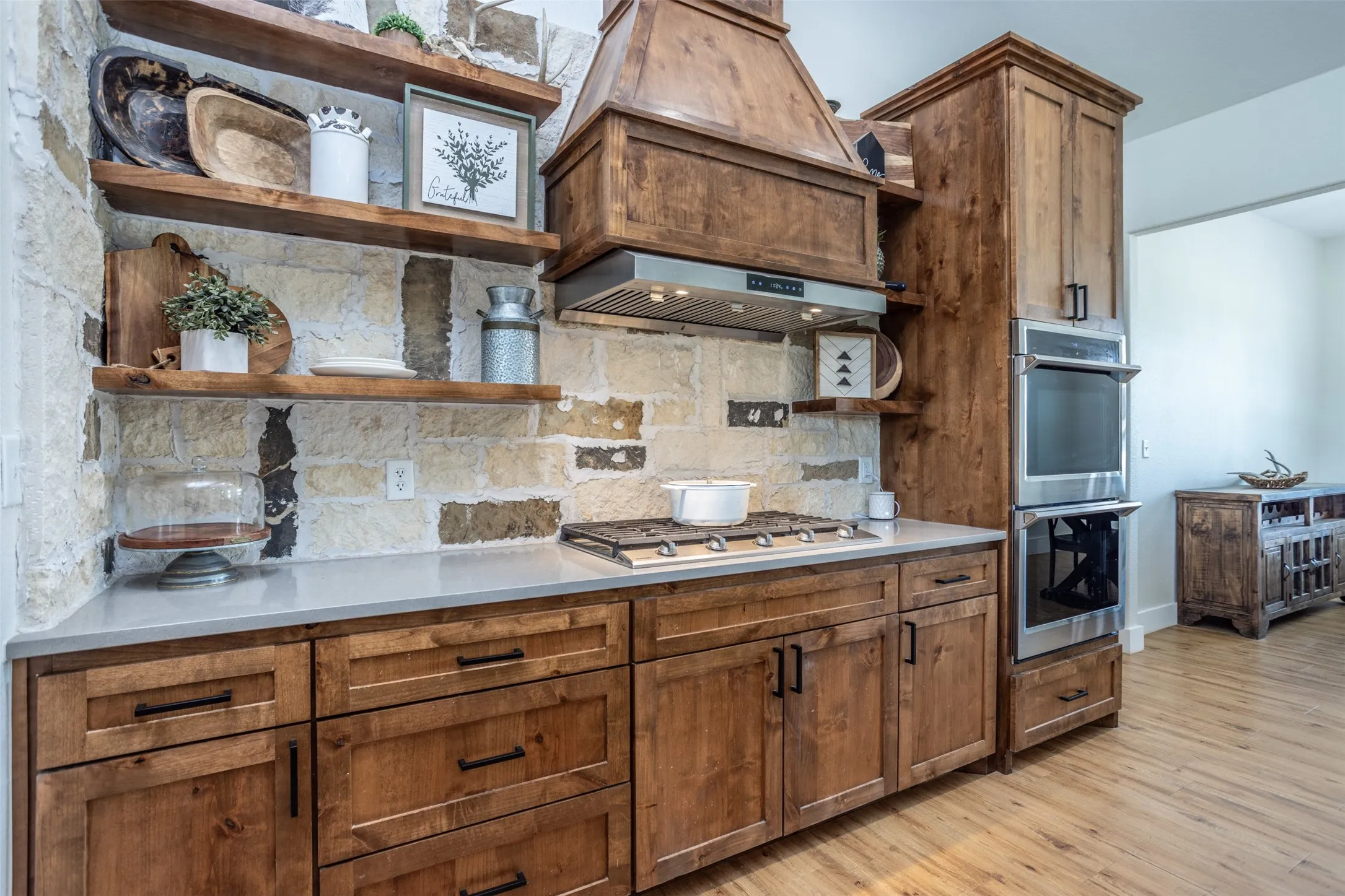 Knotty Alder venthood with Gas Cook top and double oven. stainless appliances