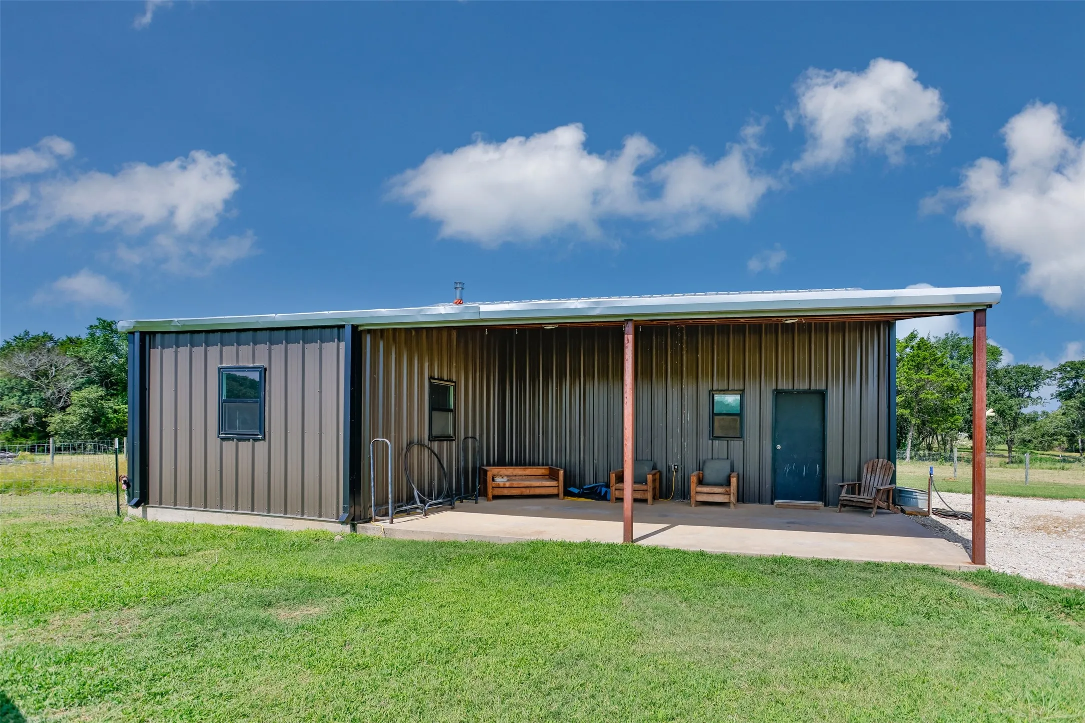 Overhang doubles as carport for the home owners.  Side room measures 14x15 for 210sf of extra space, perfect for tack room, implement parking or your own creative place