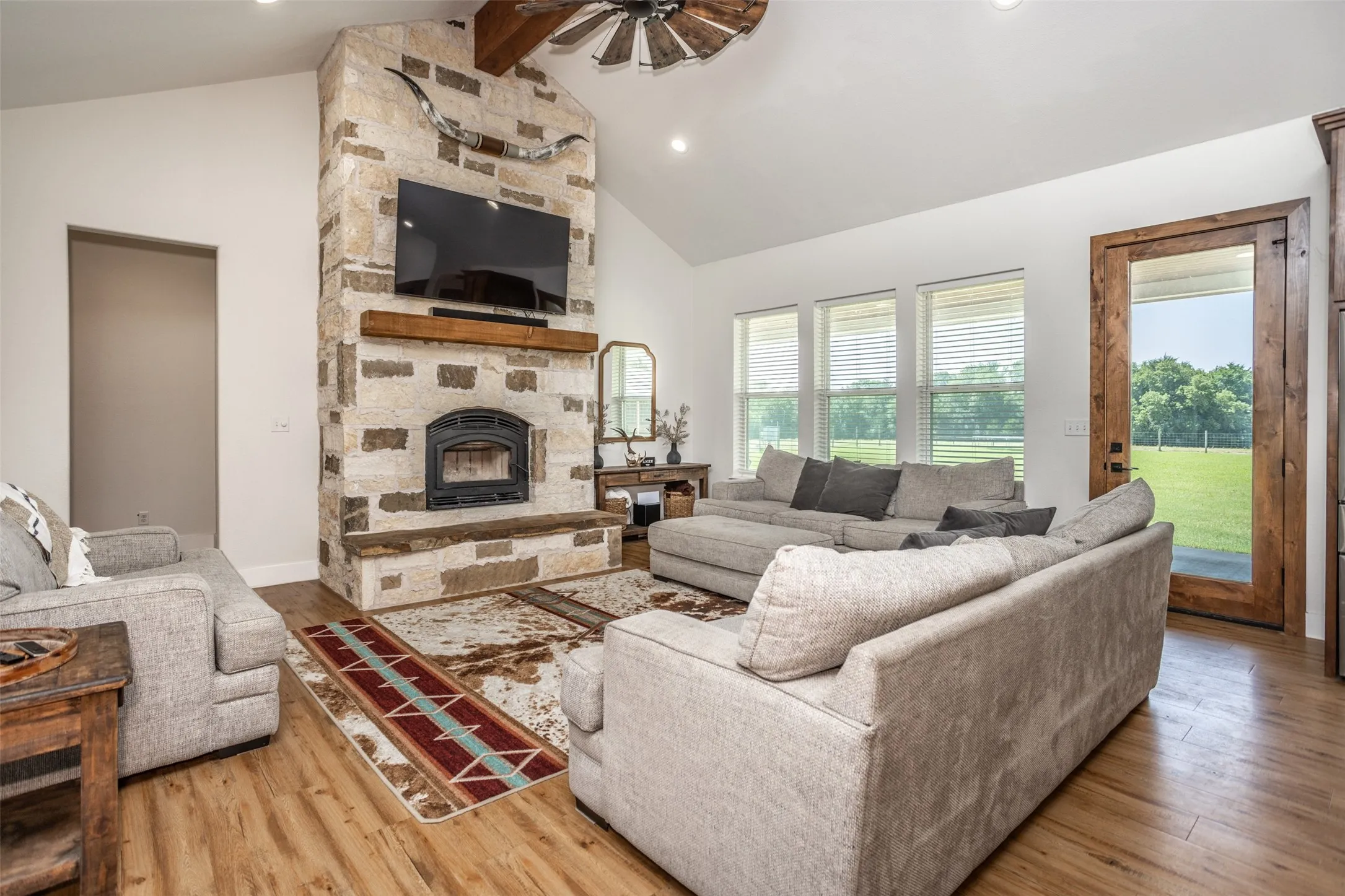 Floor to Ceiling Stone Fireplace with rustic style floating mantle and hearth