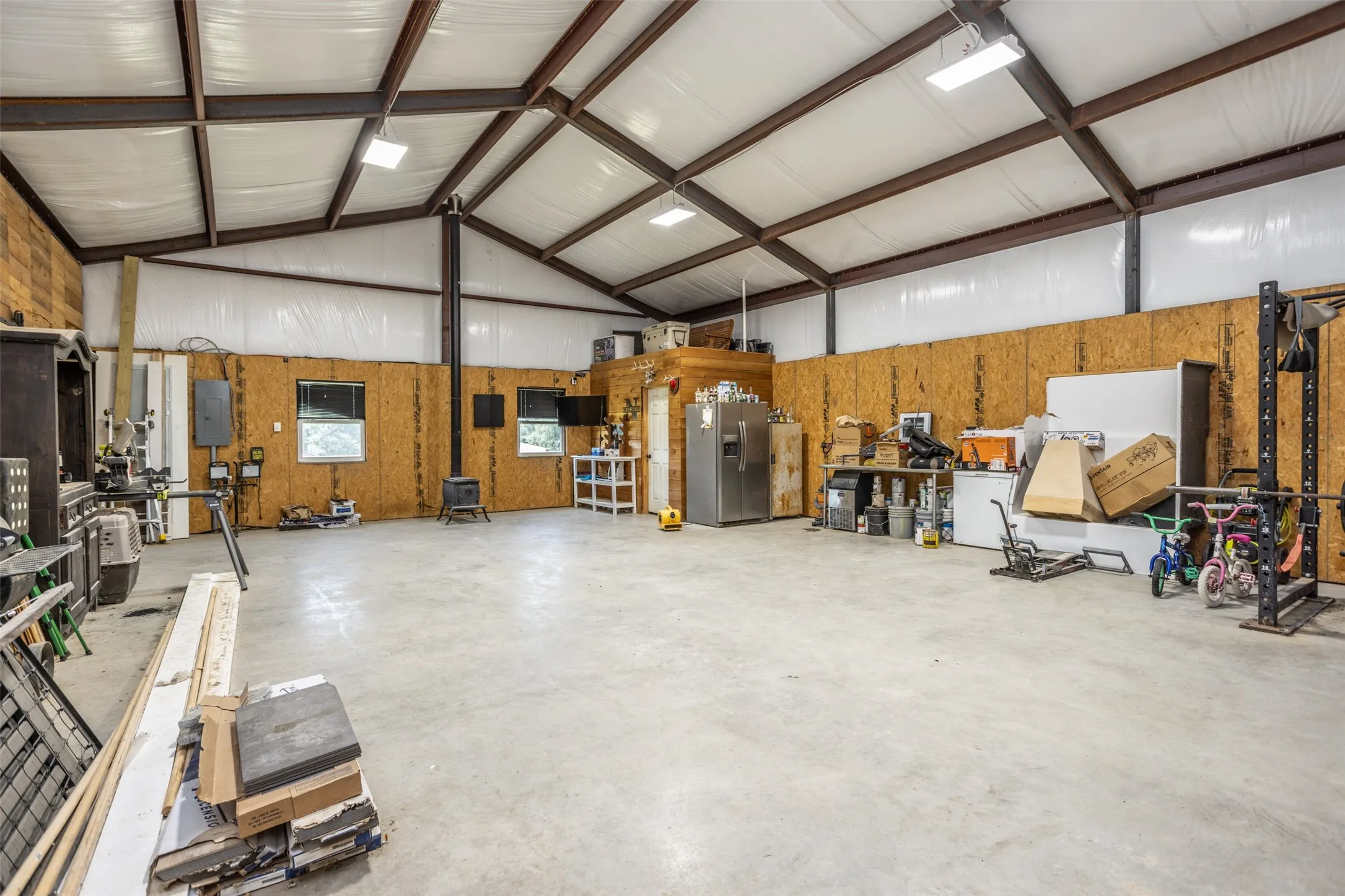 1410sf shop with insulation, electric, wood burning stove, w/d hookups, bath, and side room