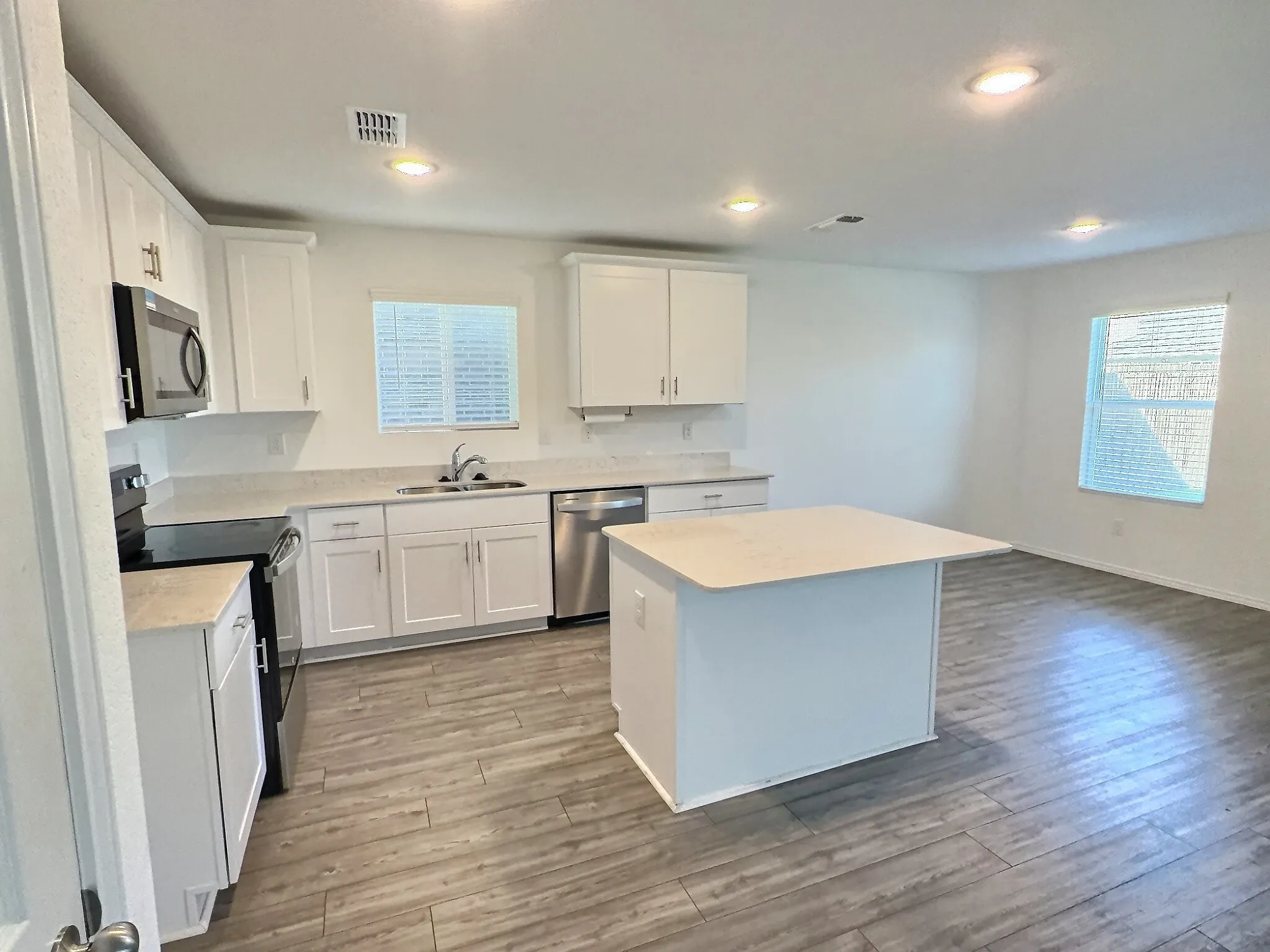 Spacious kitchen with large island open to living room and dining area