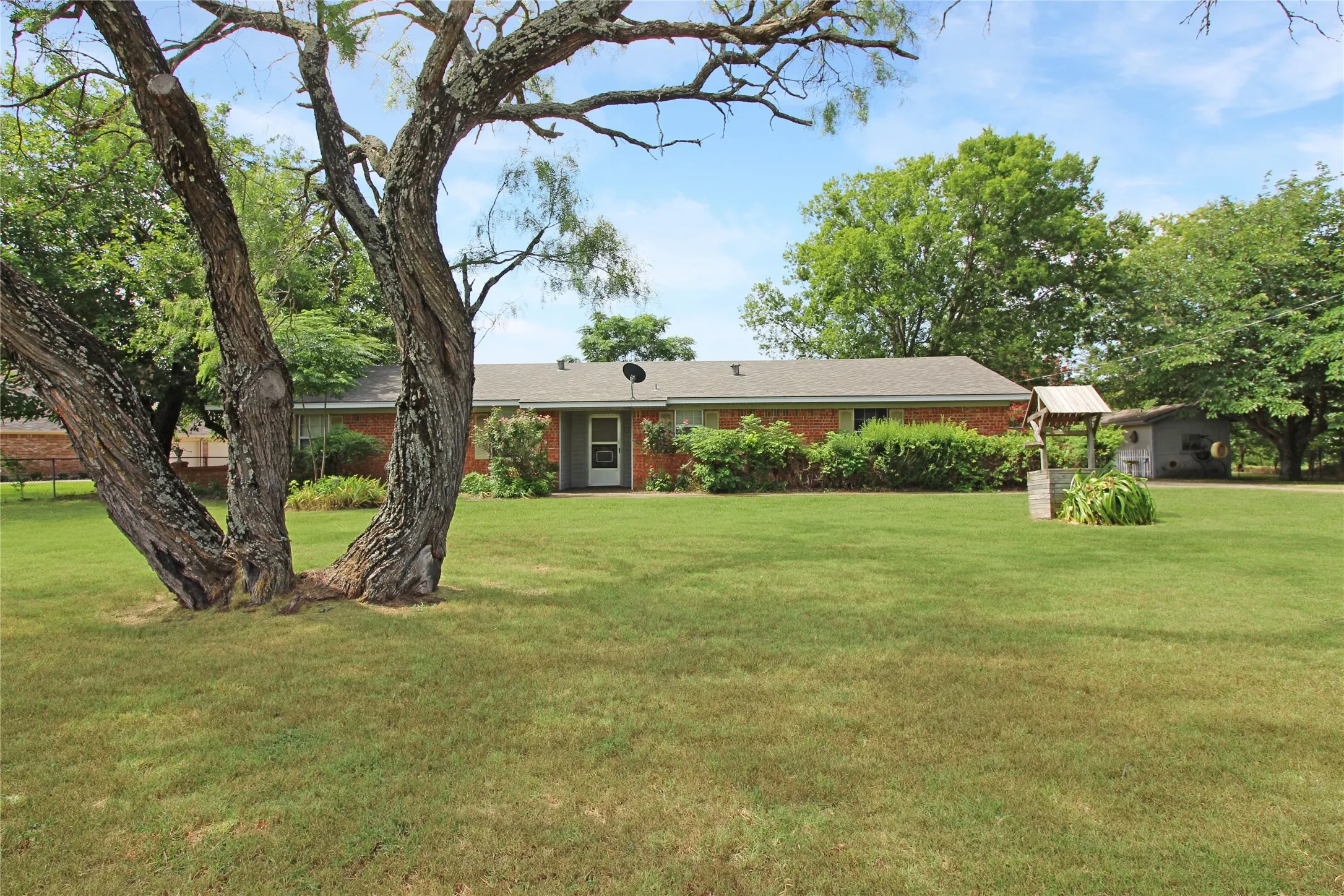 Brick ranch-style home featuring a gabled roofline