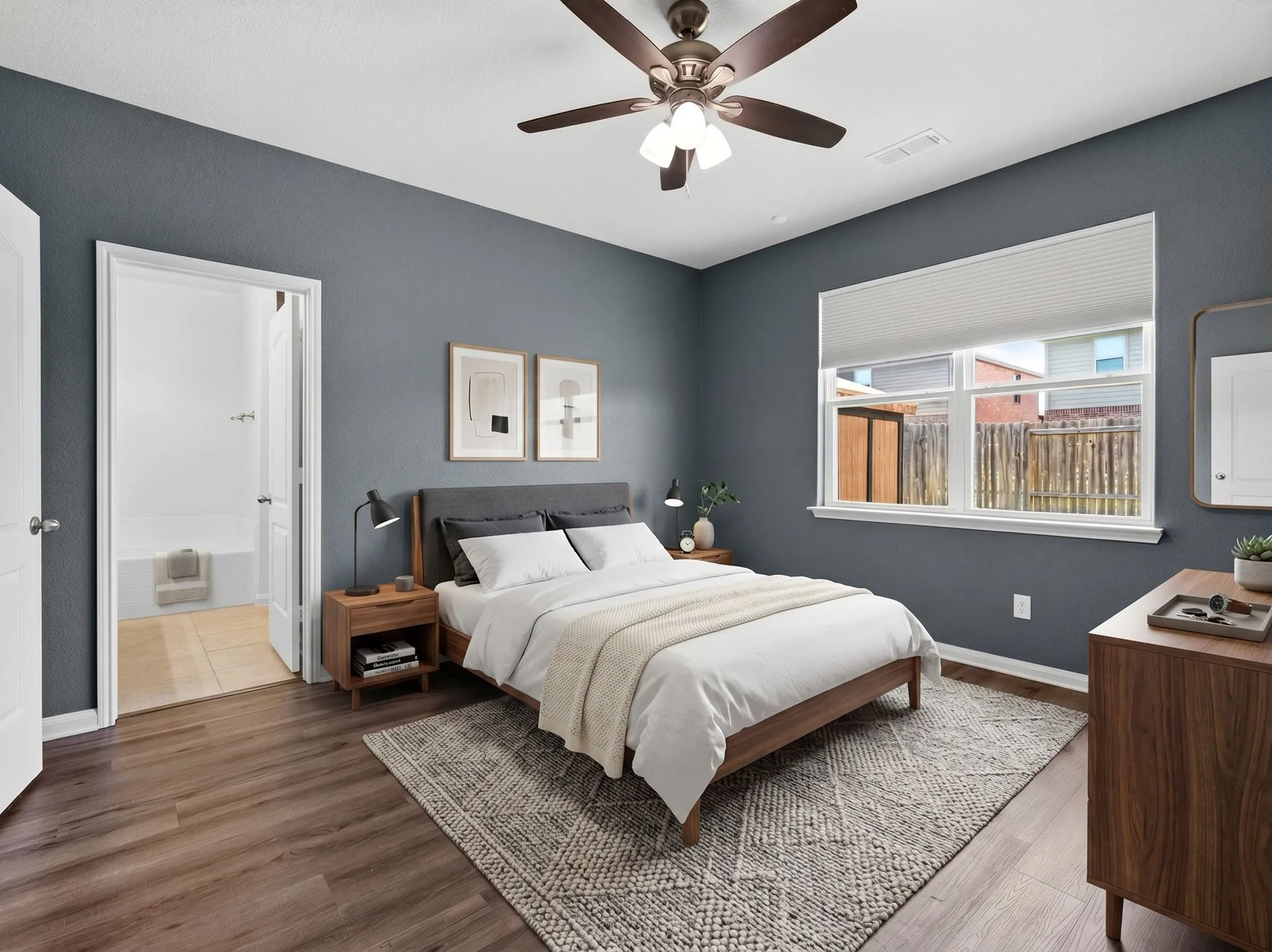 Virtually Staged Bedroom featuring wood-finish flooring, a ceiling fan with integrated lighting, and a large window with privacy blinds