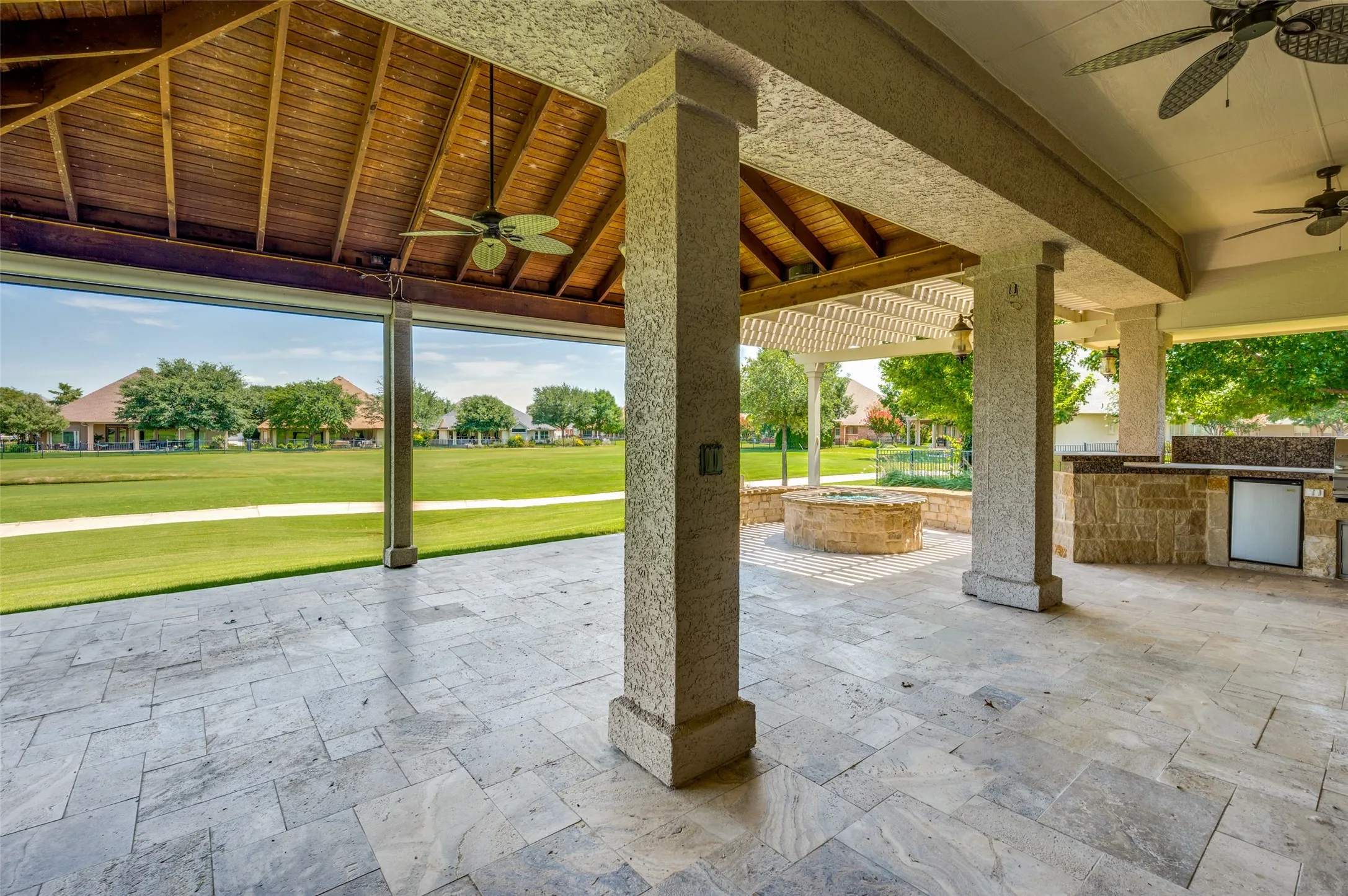 Massive Outdoor Patio on the Golf Course Tee Box has Travertine Tile, a built in Grill and Fridge!