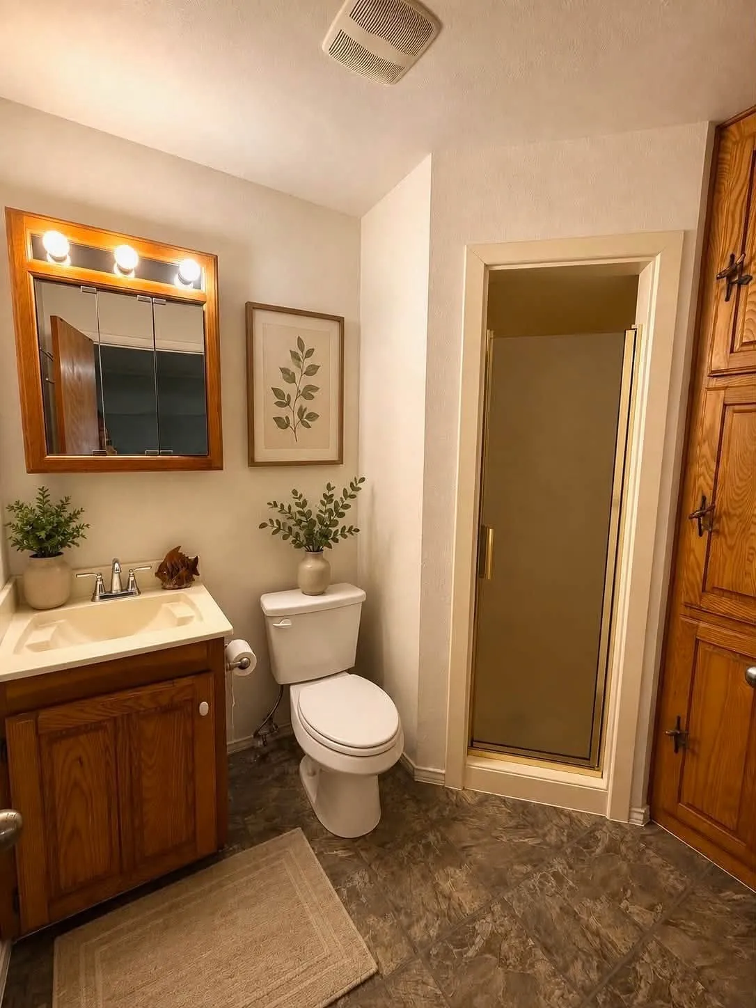 Bathroom featuring a vanity with wood cabinetry, a white basin, and a mirrored medicine cabinet