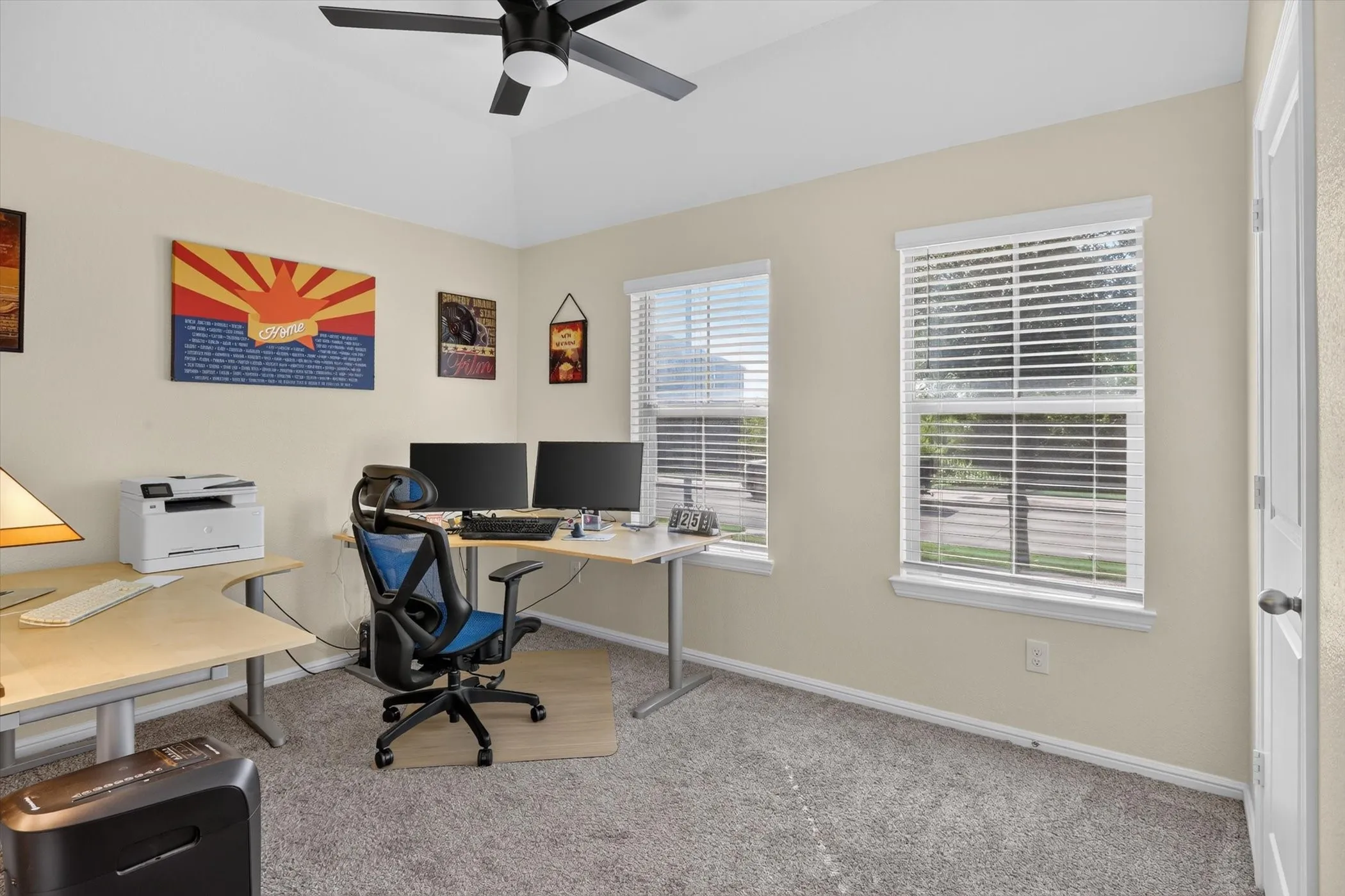 Room with vaulted ceiling and a black ceiling fan