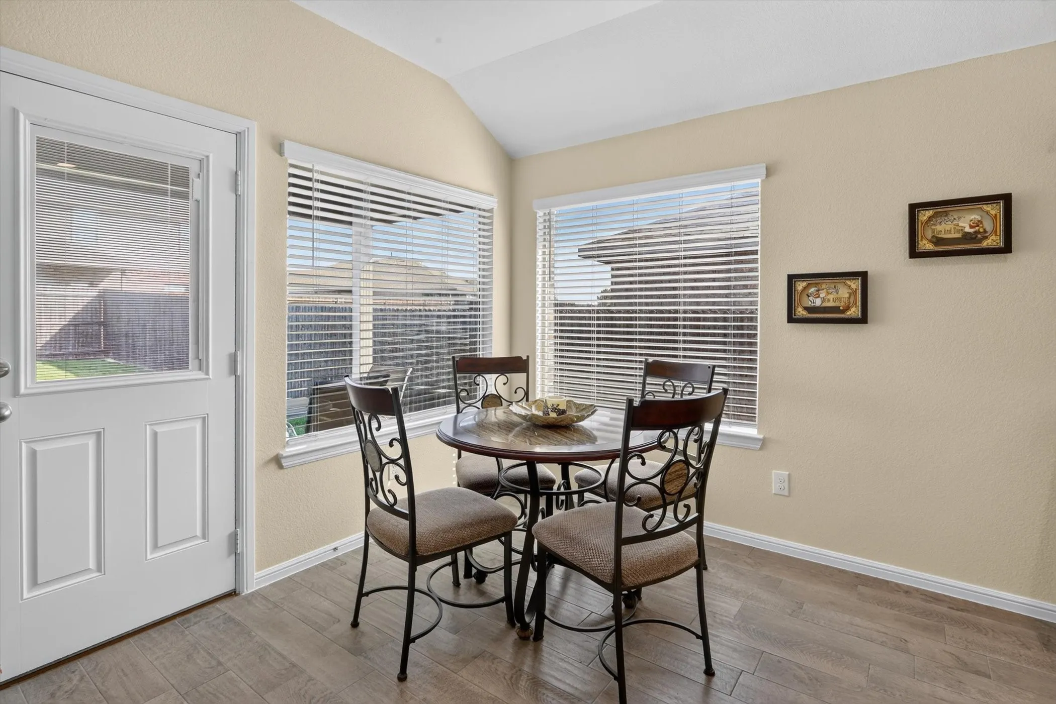 Casual dining area with wood-finish flooring and vaulted ceilings