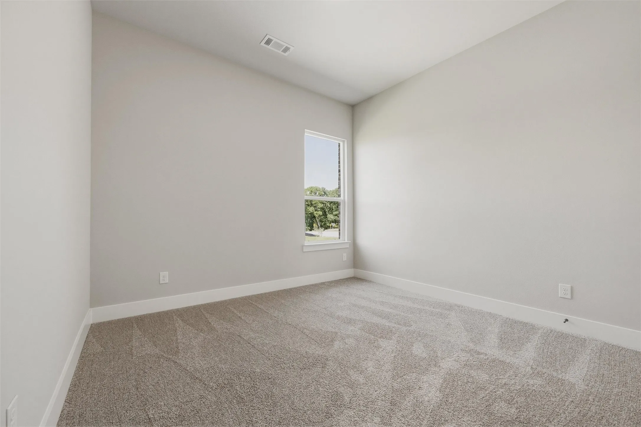 Neutral-toned walls with carpet flooring