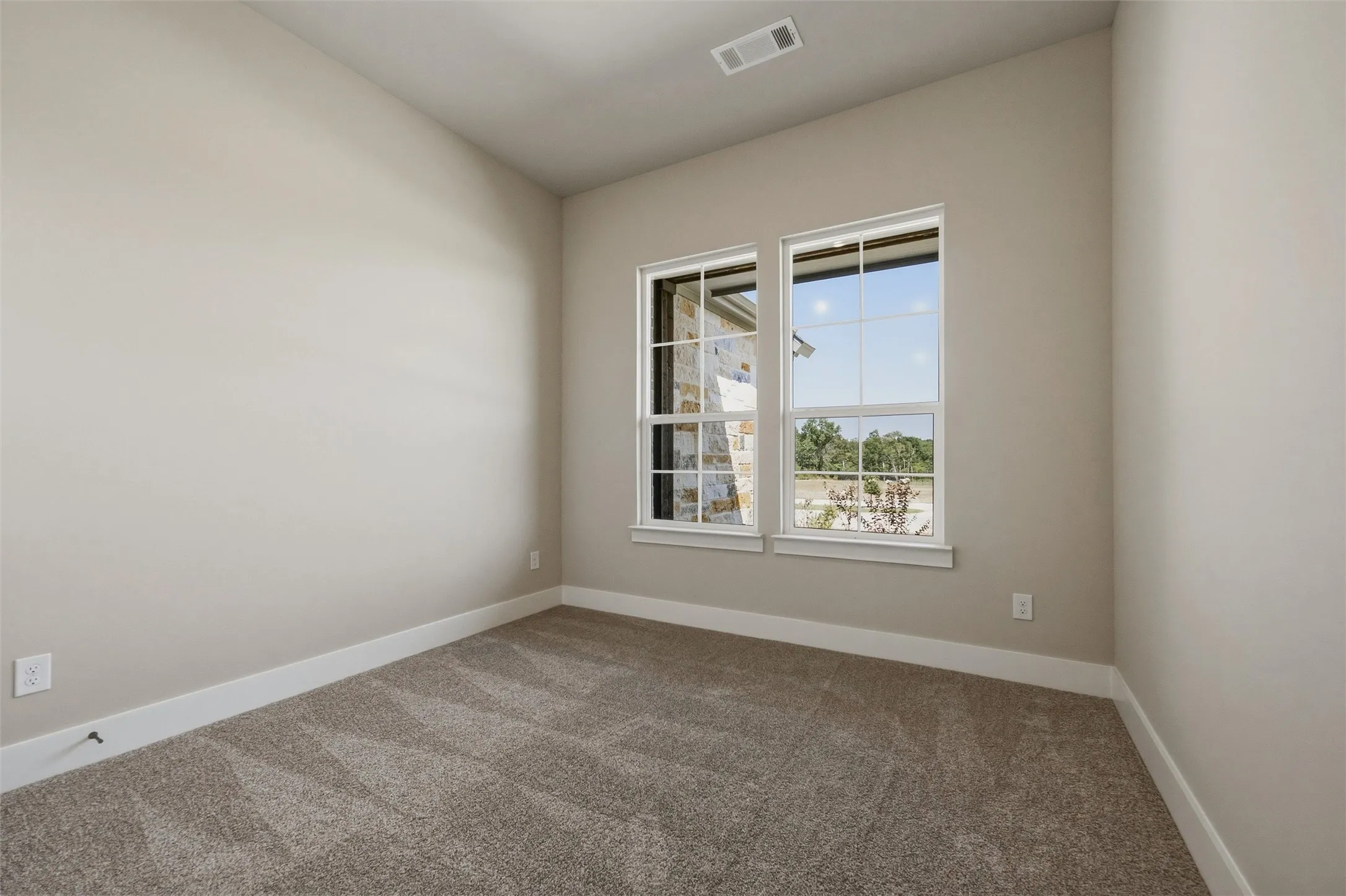 Neutral paint palette with carpet flooring and white trim