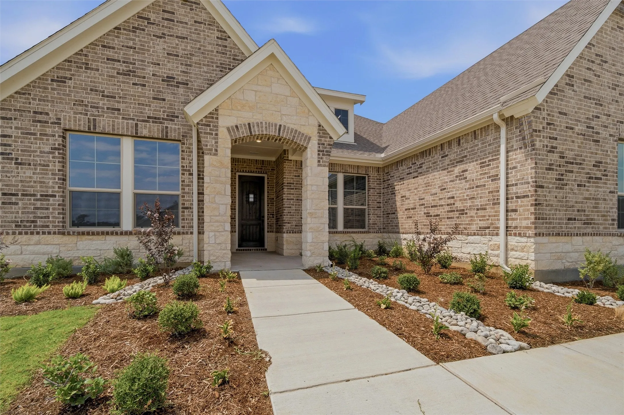 Brick and stone veneer exterior with gabled roofline