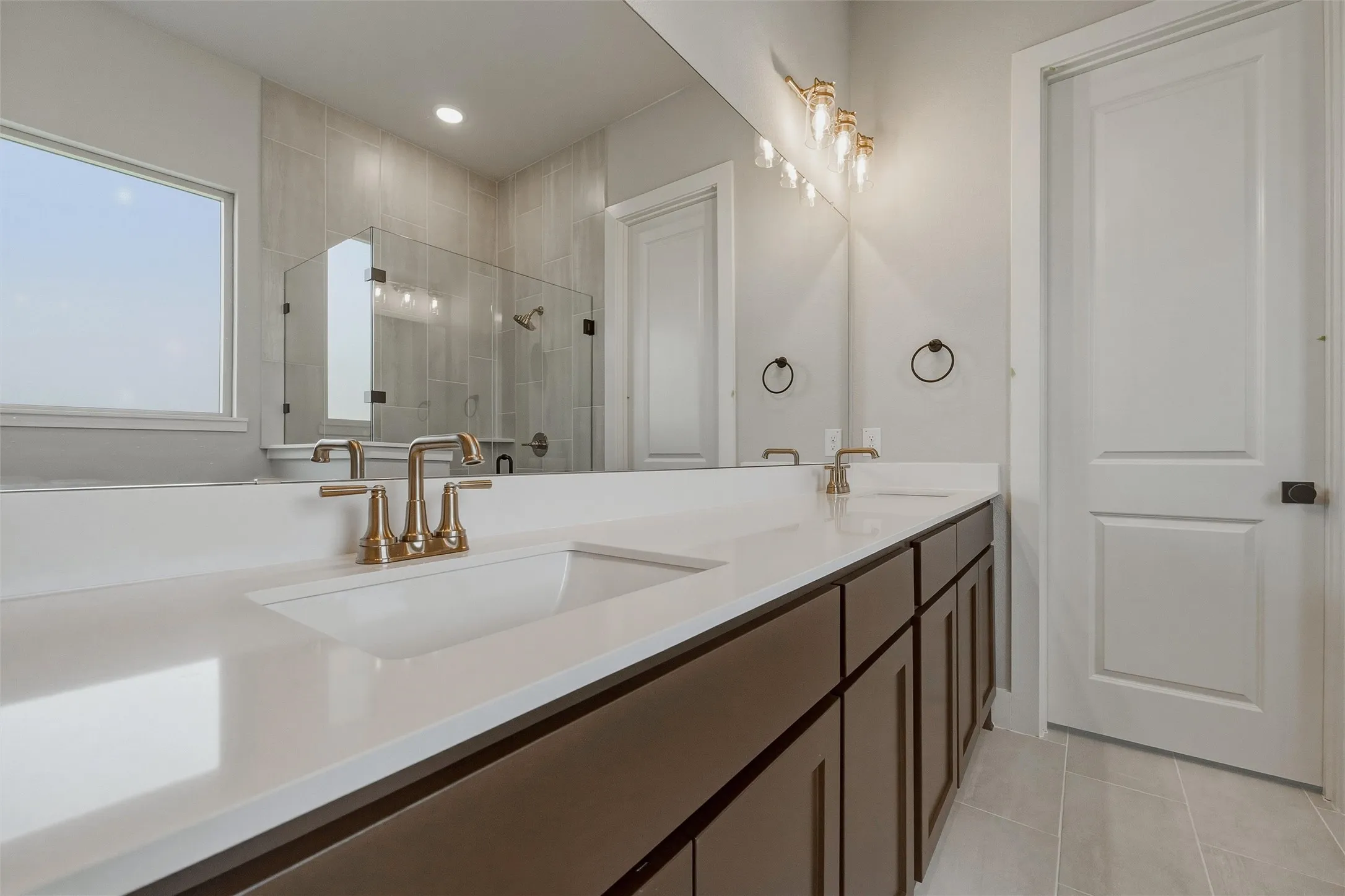 Dual vanity with integrated sinks and bronze-finish hardware