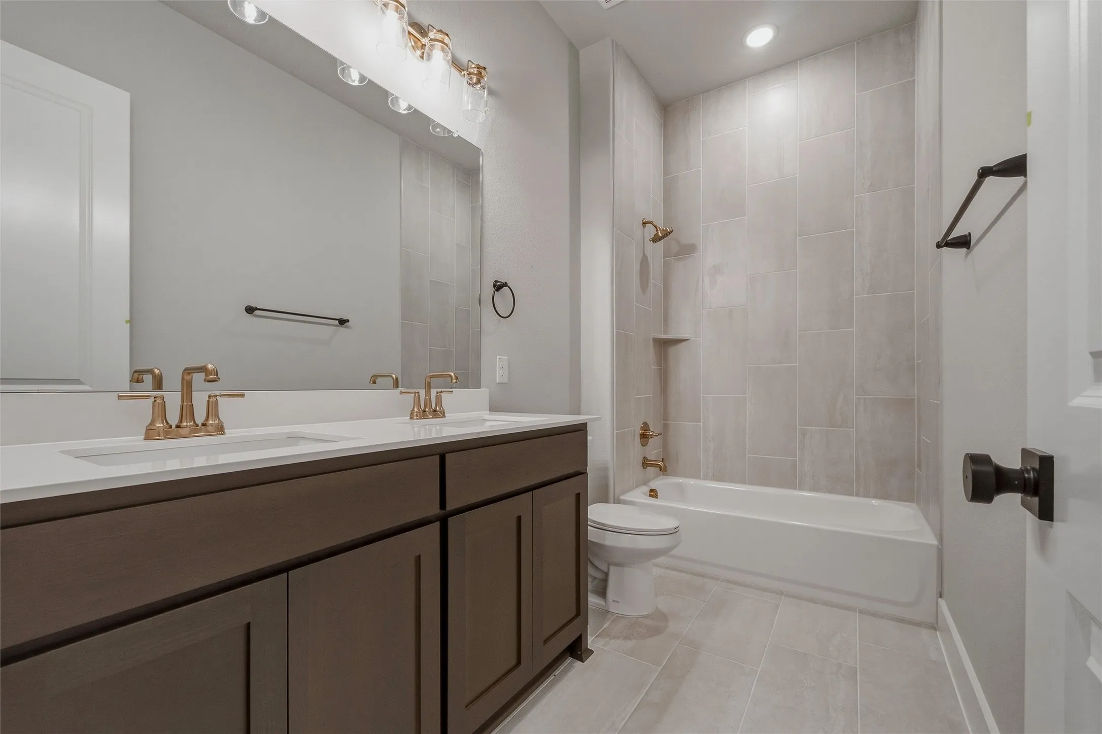 Dual vanity with bronze-finish fixtures and white countertop