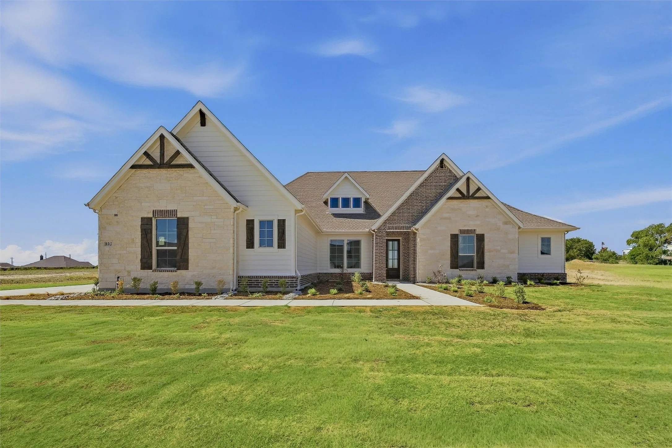 Stone and siding exterior with gabled roof lines
