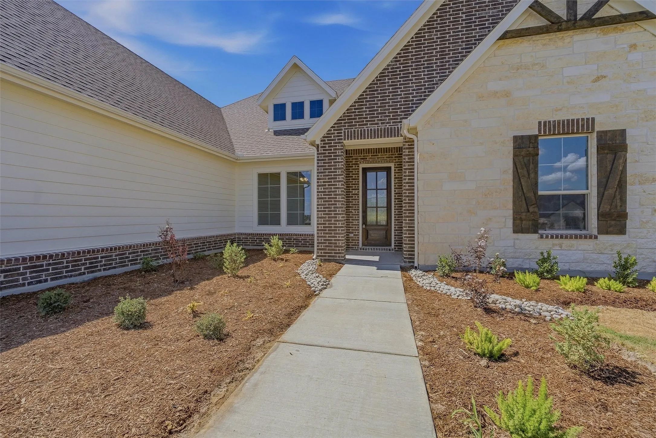 Brick and stone exterior with horizontal siding accents