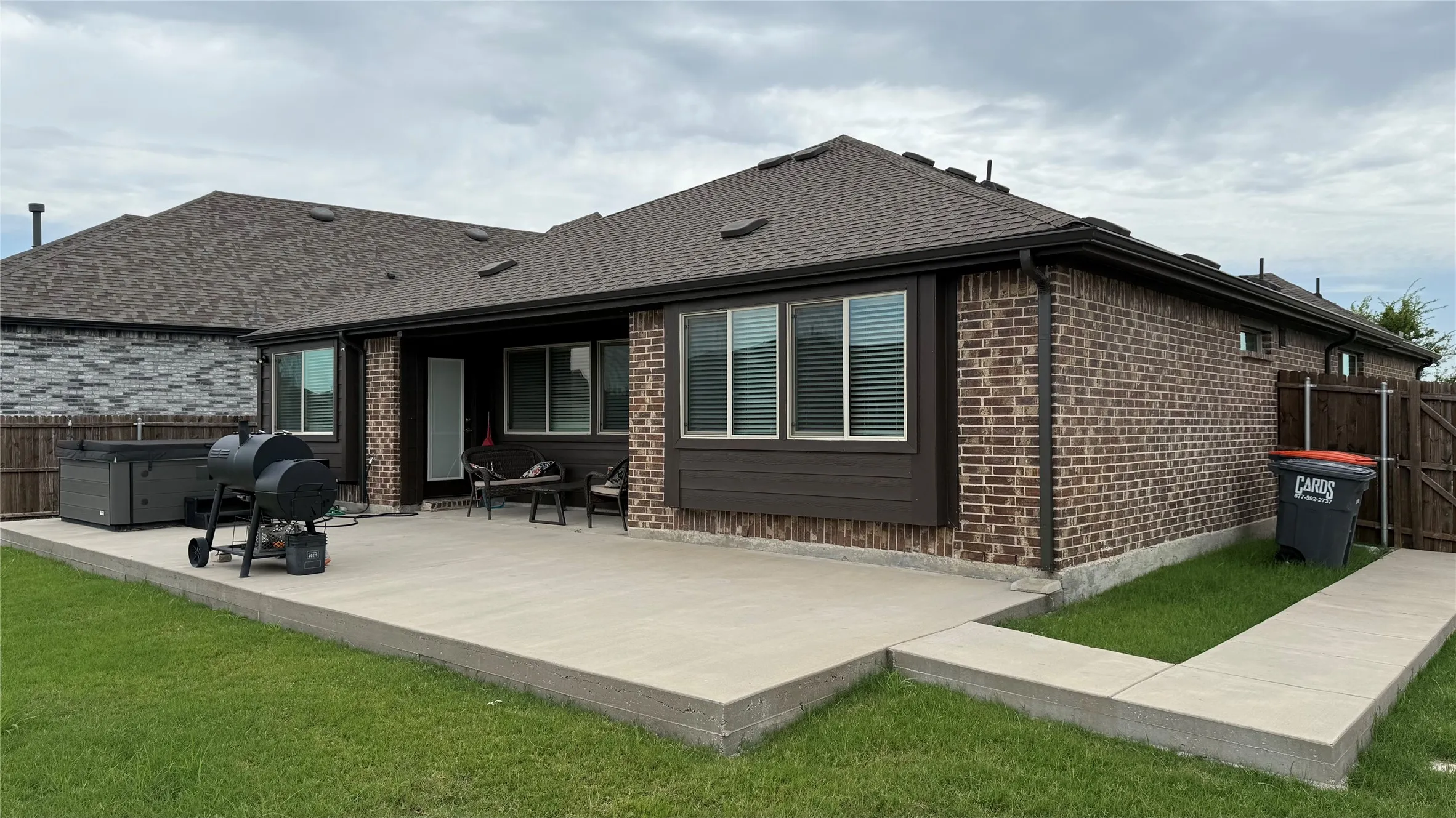 Expansive concrete patio offering generous outdoor living space