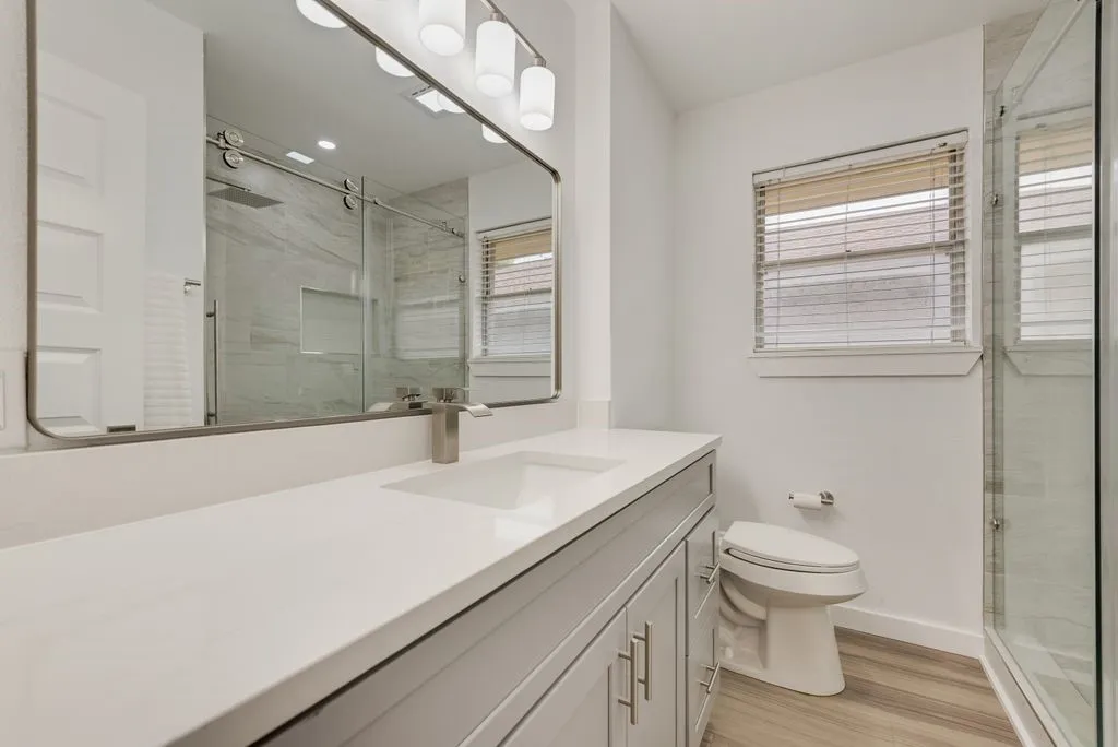 Large Full Bath completely transformed with custom tile shower and mosaic penny round shower floor and accent tile. New plumbing fixtures, and designer lighting.