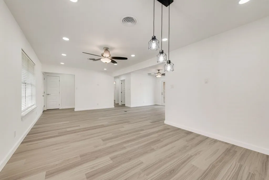 Entering the home... to your right the completely transformed open living area. Moving straight takes you to 3 bedrooms with primary facing the back. Newly created utility... so much to see.