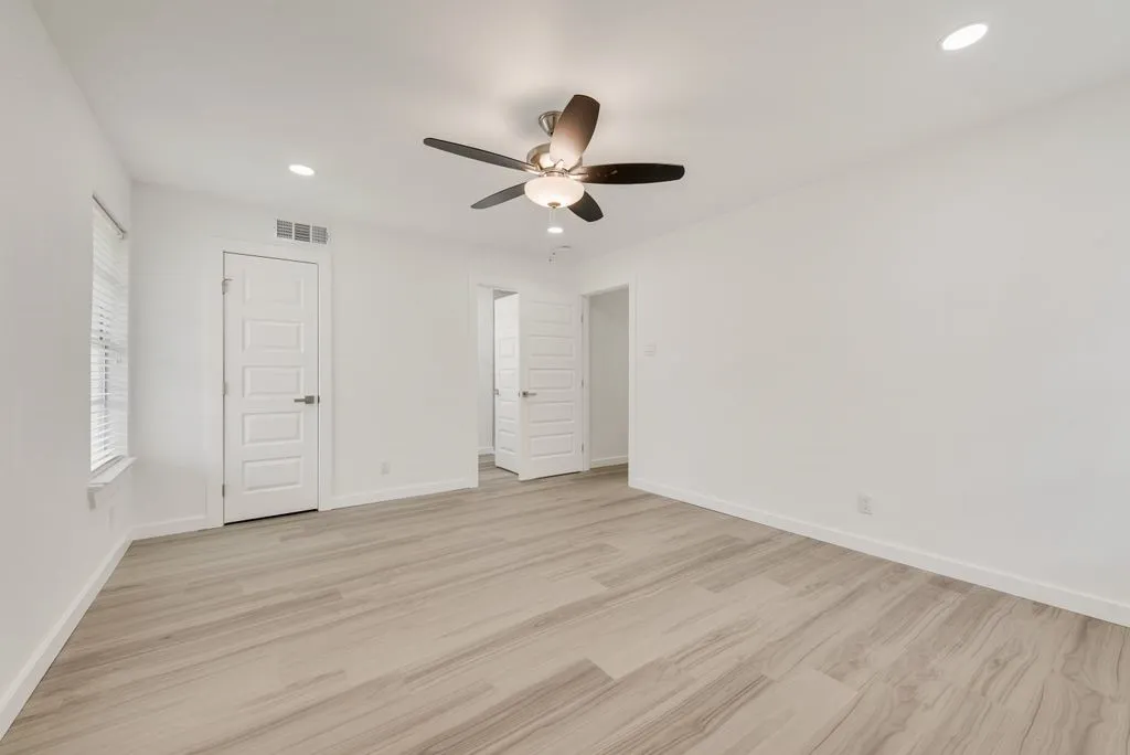 Primary bedroom with ensuite and walk-in closet. faces back