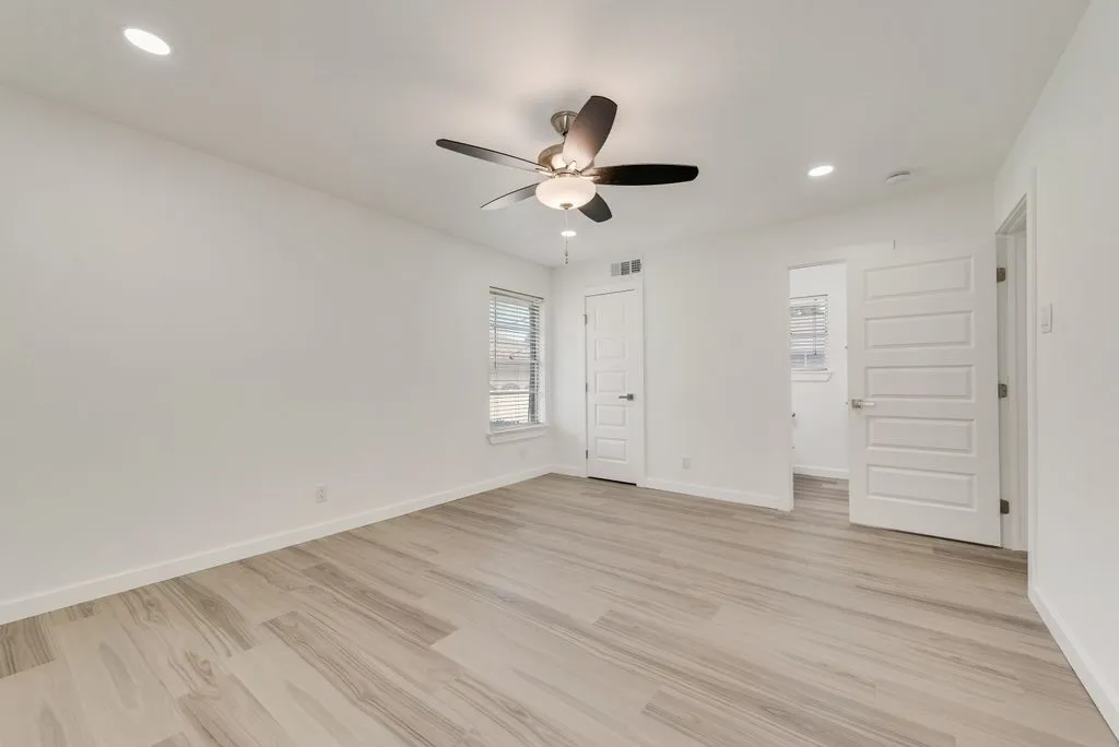 Primary Bedroom, another view, faces the back yard. Walk-in closet, Ensuite Bathroom transformed w spacious walk-in shower, new vanitie, plumbing fixtures, designer lighting.