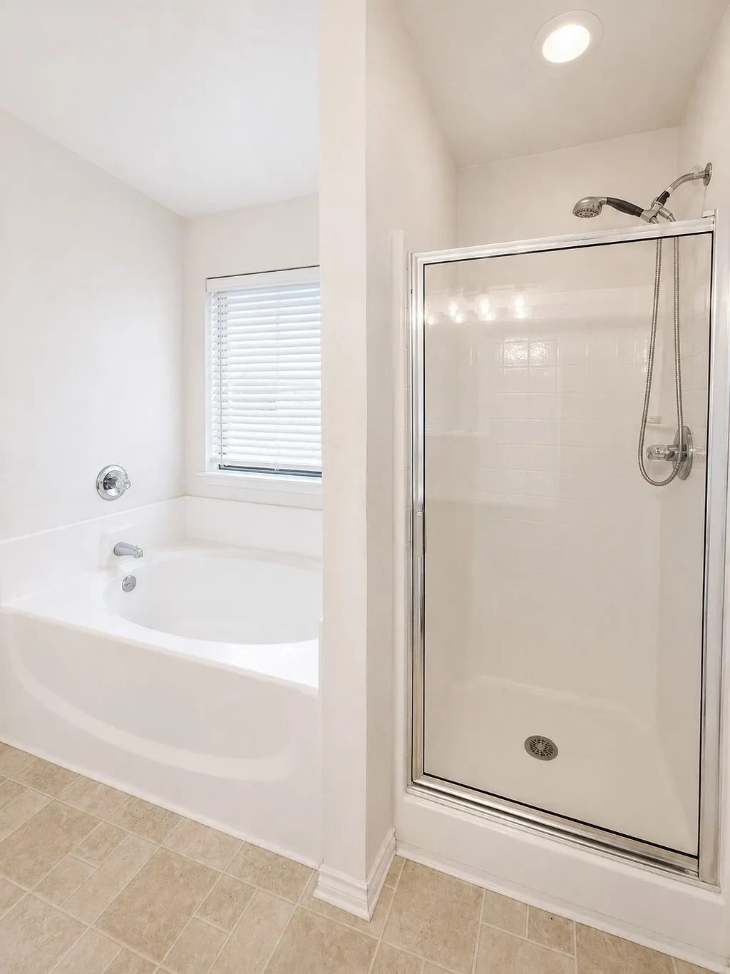 Full bathroom featuring a walk-in shower with a glass enclosure, a built-in bathtub with chrome fixtures, a window with blinds, recessed ceiling lighting, and square floor tiles