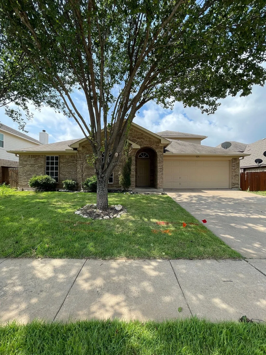 (Original photo)Single-story residence featuring a brick exterior and a two-car garage