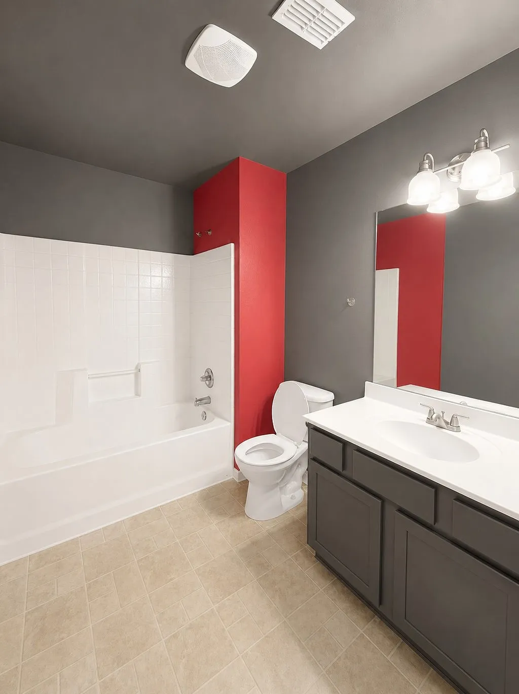 Bathroom featuring a white tub/shower combination, a vanity with a white countertop and dark cabinetry, and light-toned tile flooring