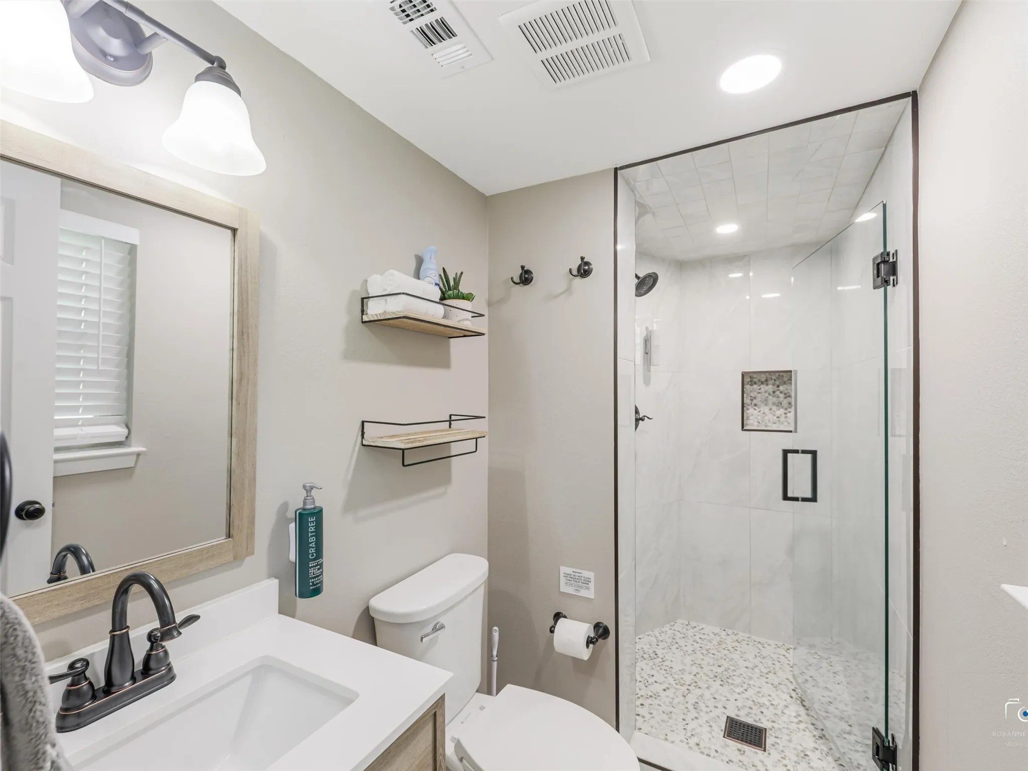 Updated primary bathroom with large enclosed frameless shower