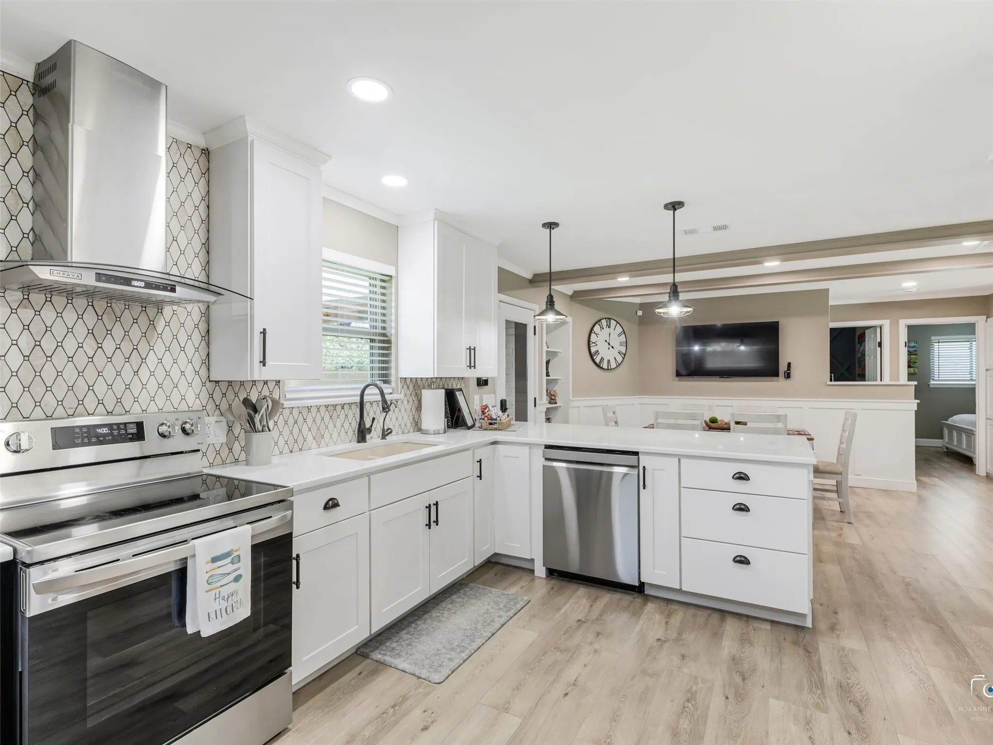 Gourmet kitchen offers plenty of counterspace, stainless appliances, and designer cooktop vented hood