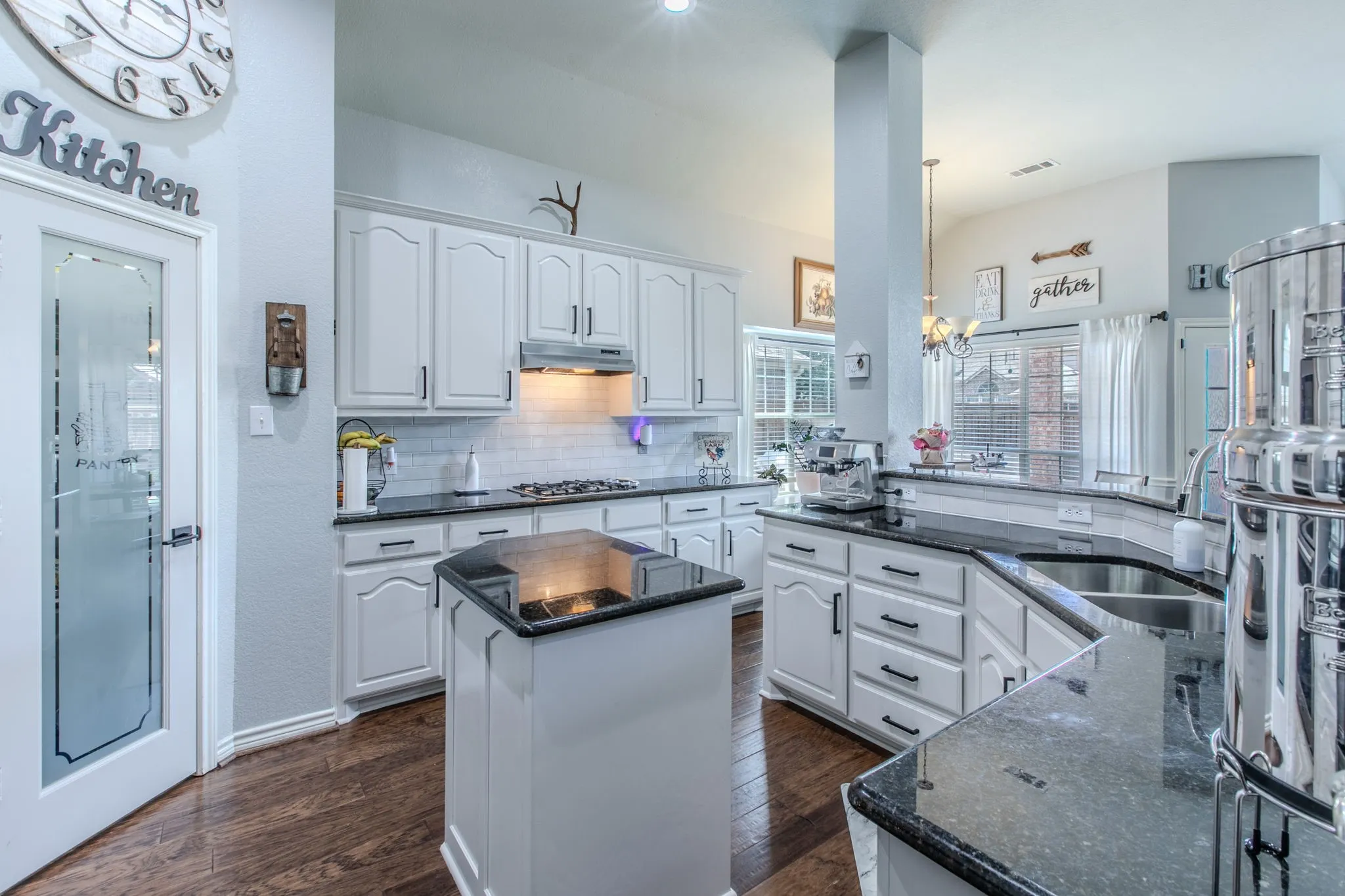 island and painted cabinet w stainless appliances.