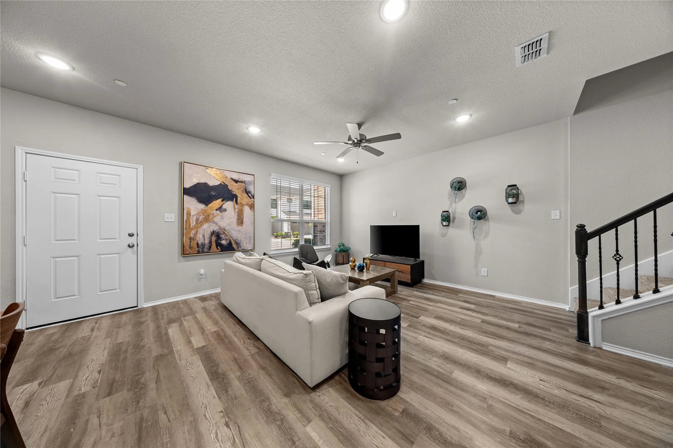 Spacious interior with wood-finish flooring, recessed lighting, and a ceiling fan