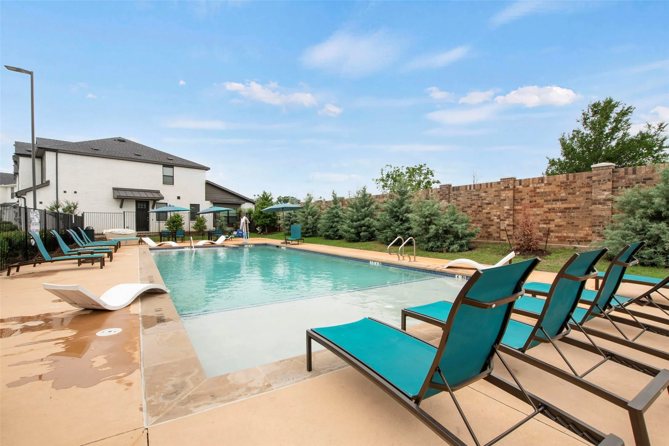 Inviting swimming pool featuring a tanning ledge and integrated steps