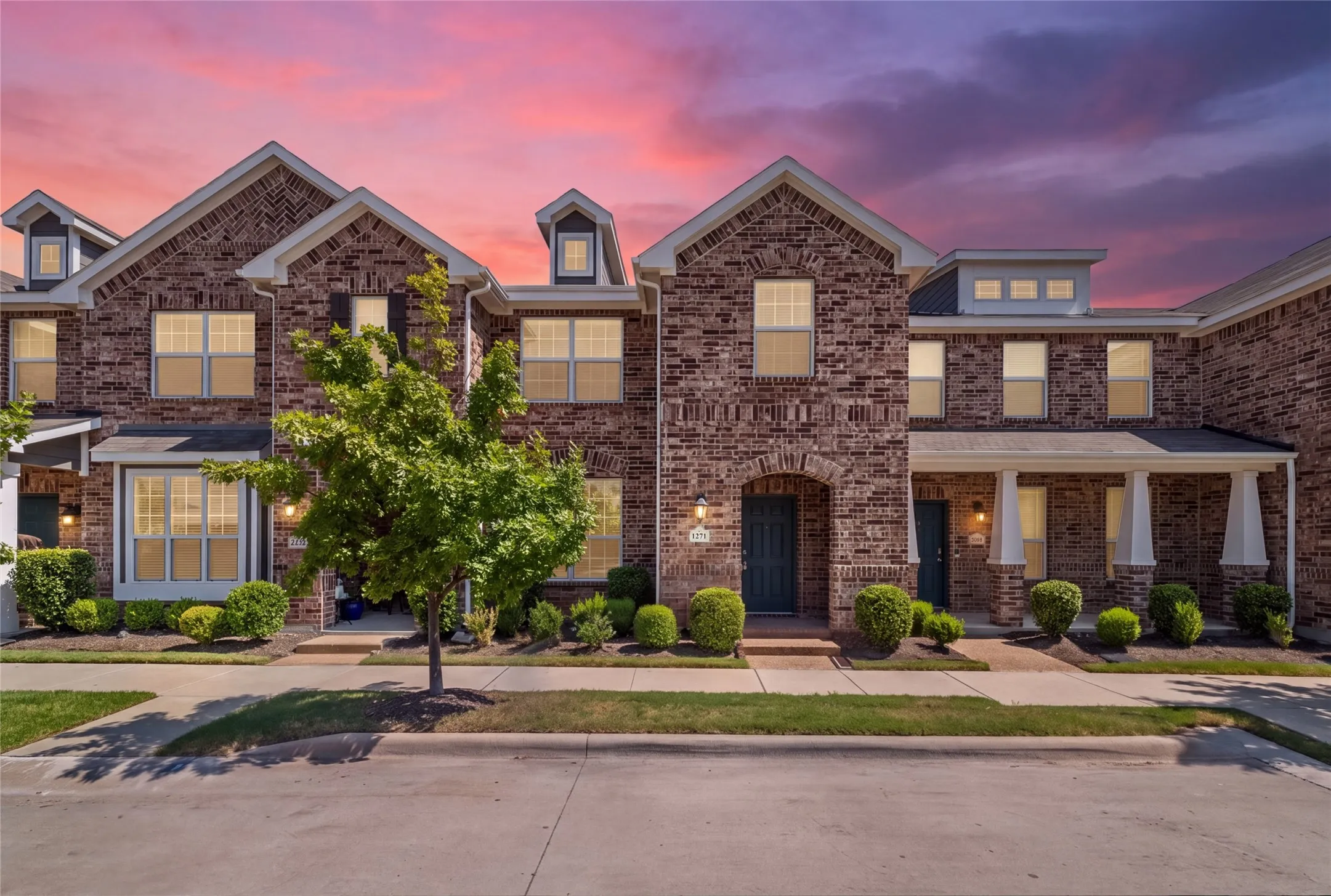 Elegant brick Colonial featuring a symmetrical façade with multiple gabled rooflines and dormer windows